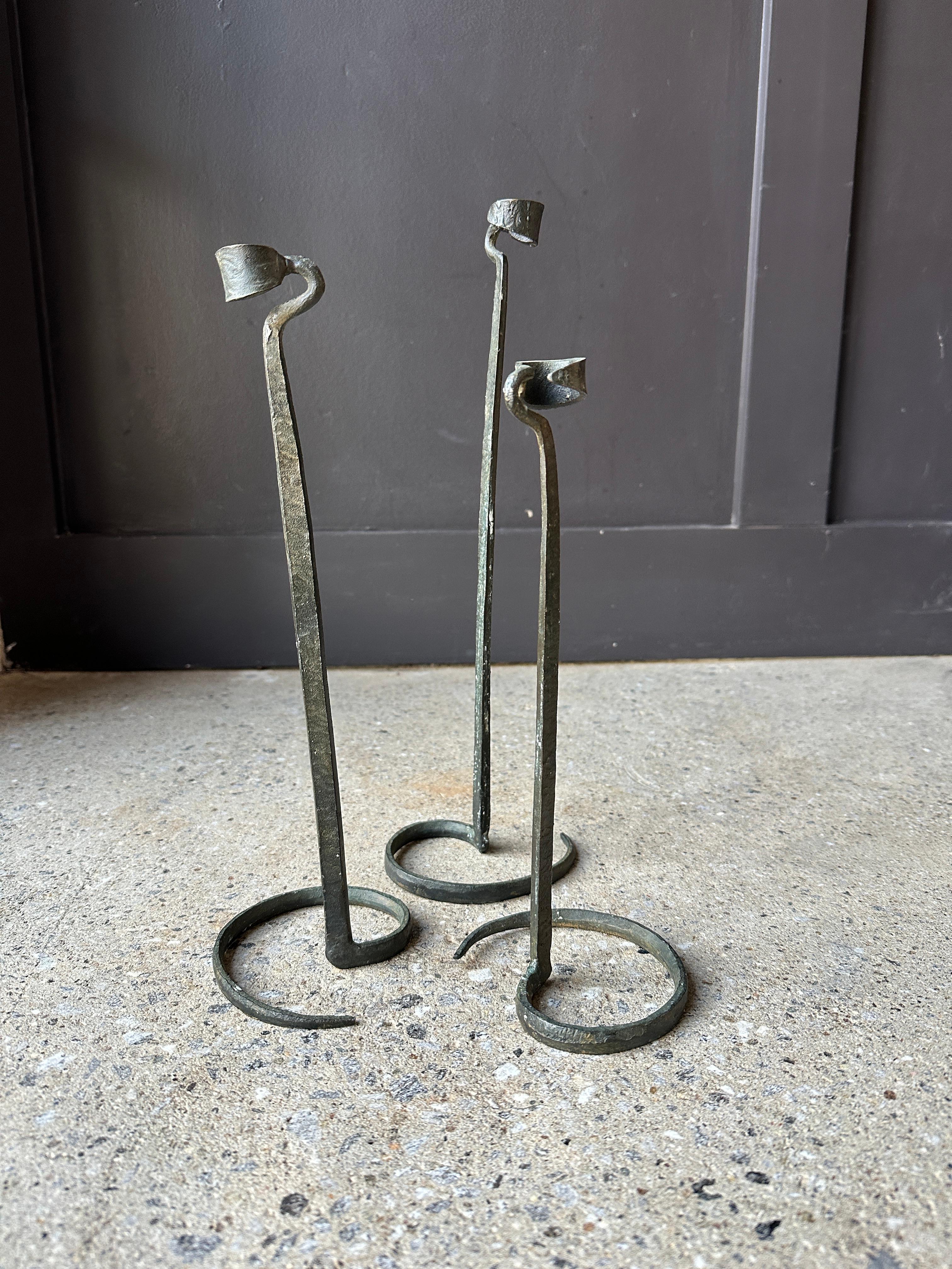 Set of 3 sculptural vintage brutalist hand-forged candlestick holders, reminiscent of the work of metalsmith Lance Cloutier featuring spiraled forms. Circa 1980s.

Excellent condition, normal vintage wear.

14.5”, 12.5” and 11” Height. Price is for