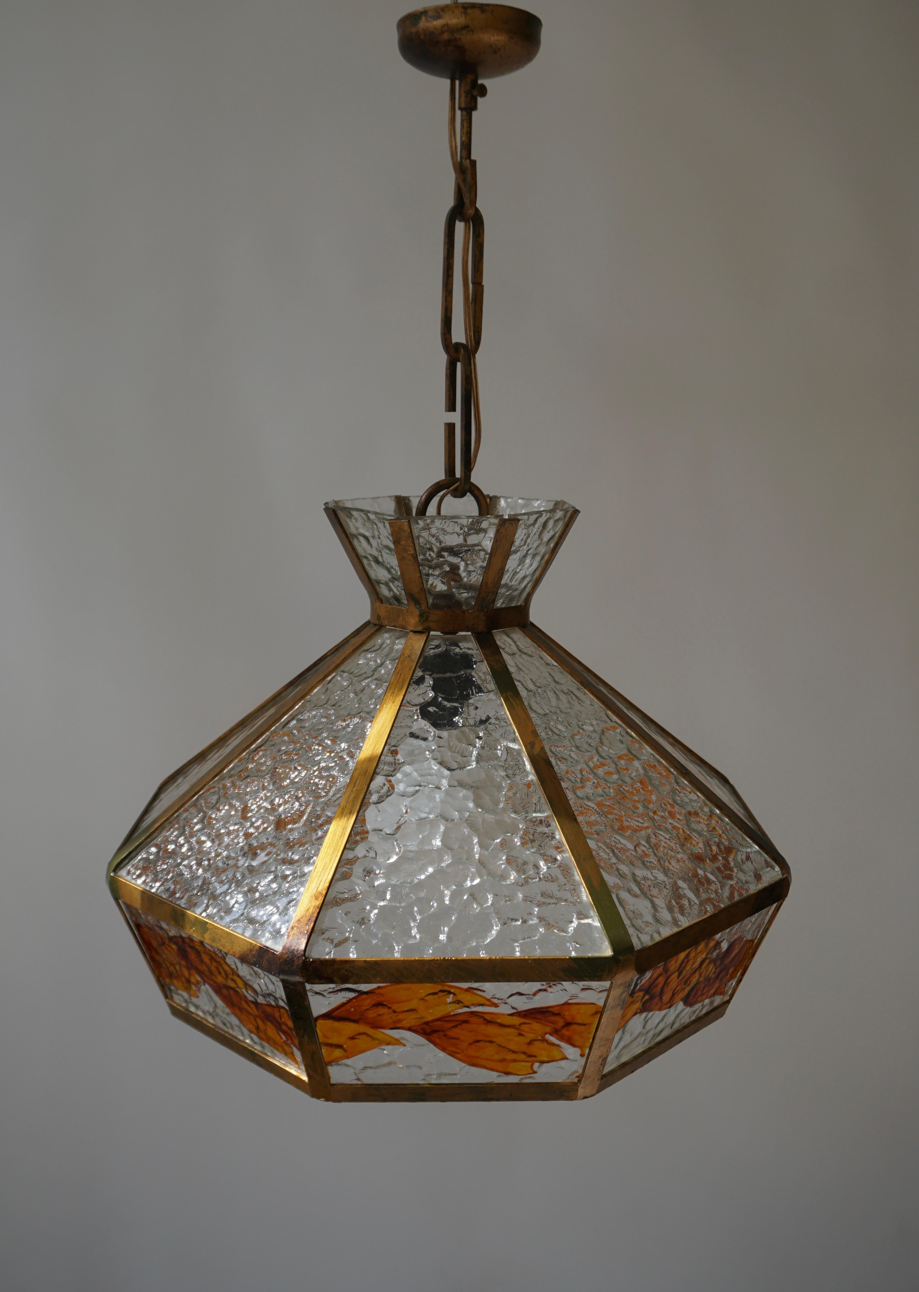 Brutalist hand painted stained glass chandelier and signed by the artist.

Dimensions are;
Diameter 50 cm.
Height fixture 35 cm.
Total height 70 cm.
Weight 3 kg.