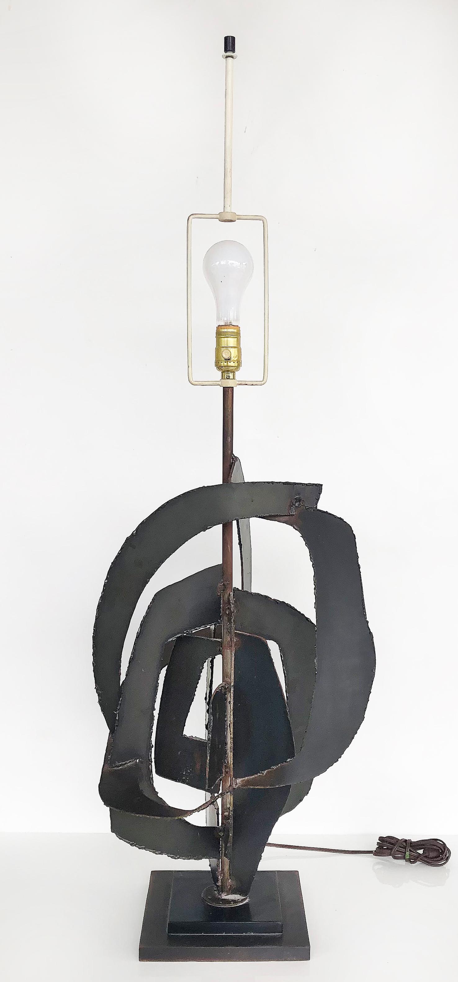 Brutalist Harry Balmer Laurel Lamp Torch Cut Iron Lamp, circa 1970

Offered for sale is a brutalist torch cut iron table lamp designed by Harry Balmer for Laurel Lamp Co. circa 1970, The lamp is sold together with its original shade. The lamp
