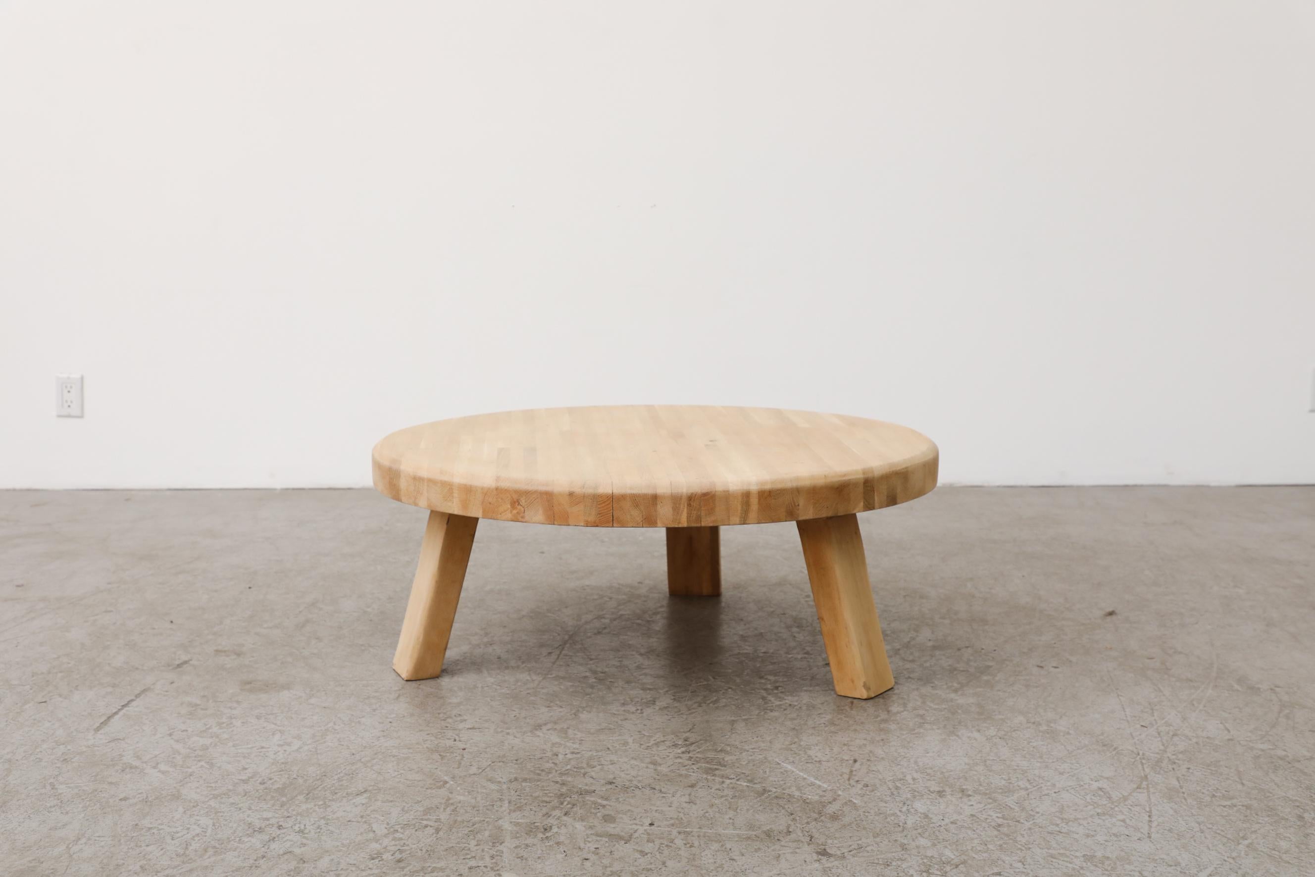 This stunning, Brutalist heavy round coffee made from solid oak with three sturdy square legs is in original condition with visible wear and patina consistent with its age and use.