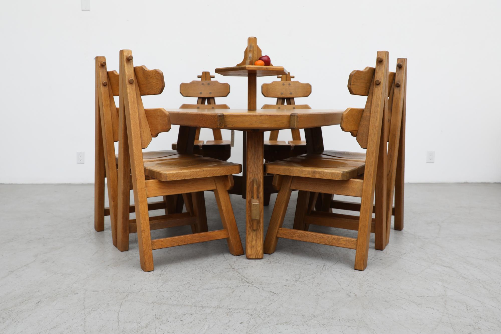 Brutalist heavy oak triangular dining table with built in centerpiece. A triangular trestle base with peg tension construction. The Lazy-Susan is 18