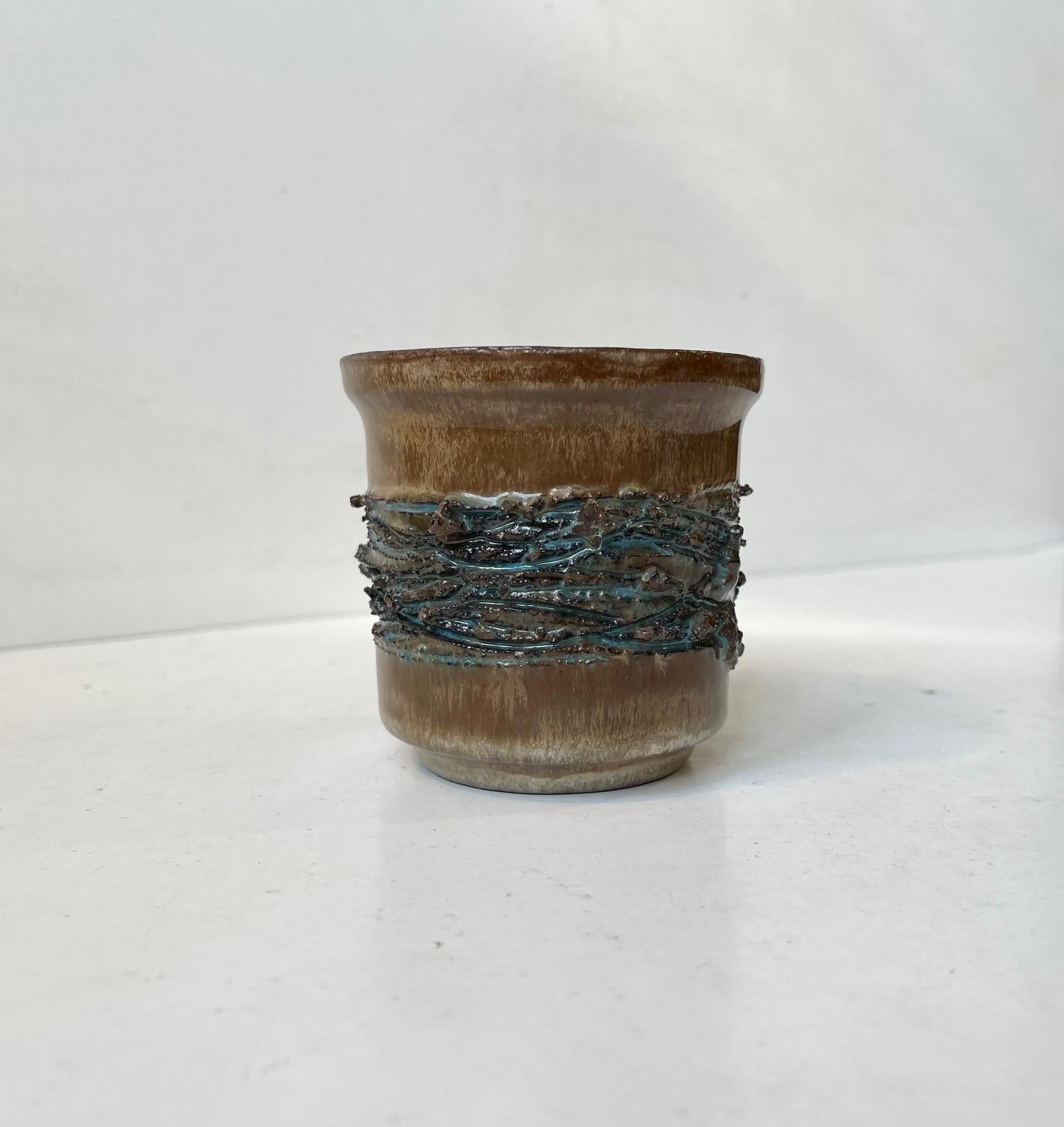 HF Gilt is a renowned Icelandic ceramic pottery studio. The clay used in this piece is made from pumice stone collected from Icelandic volcanos. The texture partially decorated with vibrant blue glaze is also created using real lava collected from