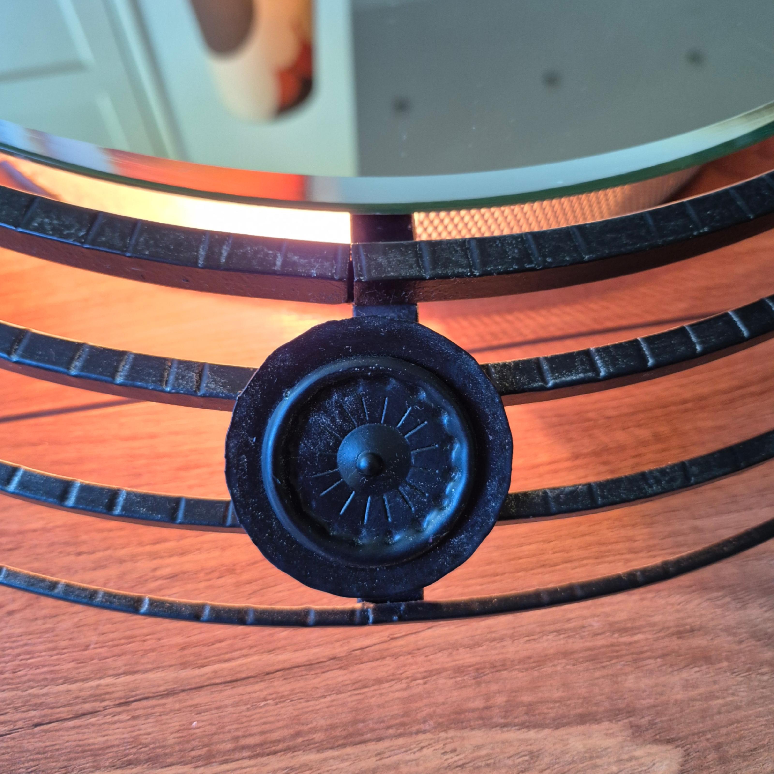 Round brutalist mirror. Made from wrought iron.
It is illuminated from the back by 4 lamps operated by a pull switch.
The mirror itself measures 42cm in diameter.

It shows likeness to the works of Jean Tourette and Atelier Marolles.

The mirror is
