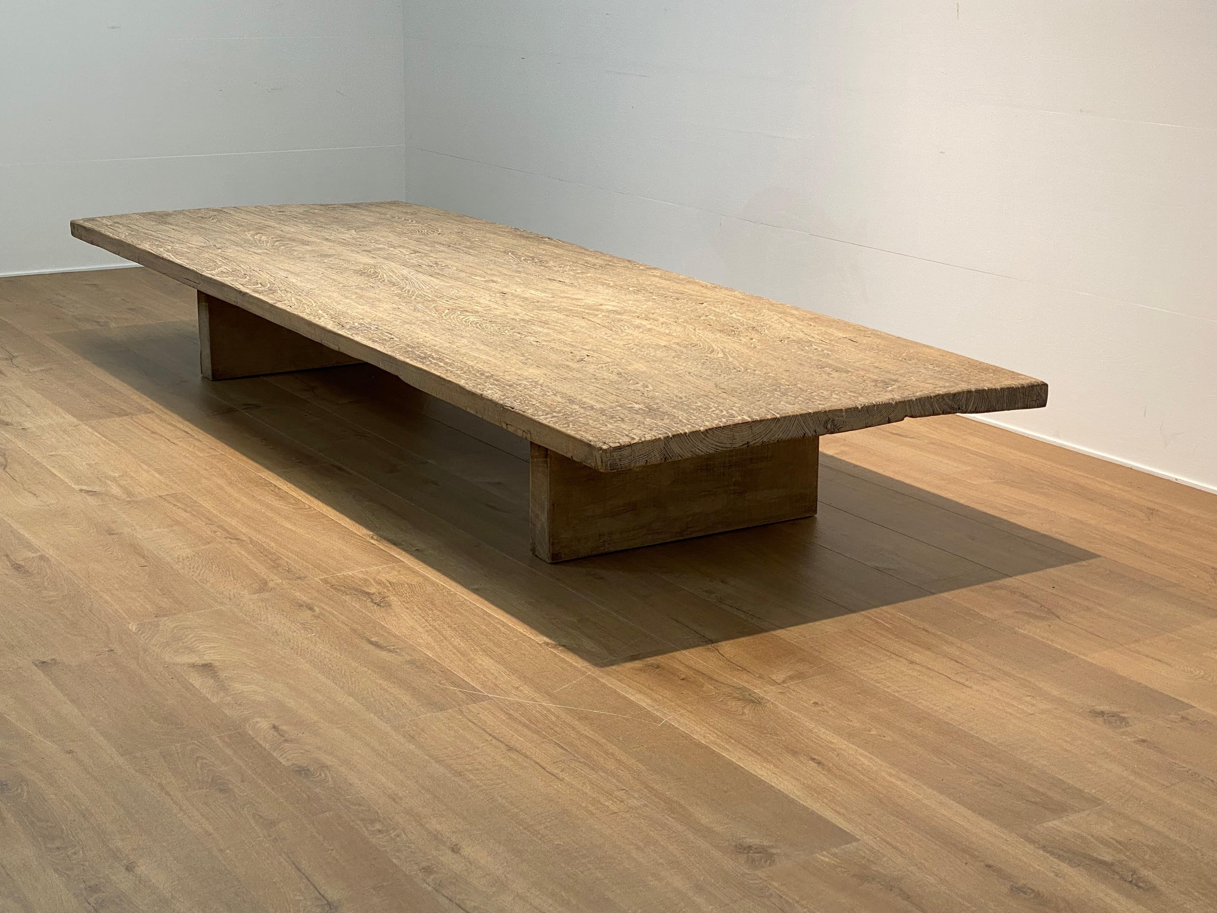 XXL-Brutalist  Tisch aus gebleichtem Elmwood,
Die Tischplatte steht auf einem modernen Holzsockel,
großer Glanz und Patina des gebleichten Holzes,
die Tischplatte weist Anzeichen alter Restaurierungen auf,
sehr leistungsfähiges Möbelstück