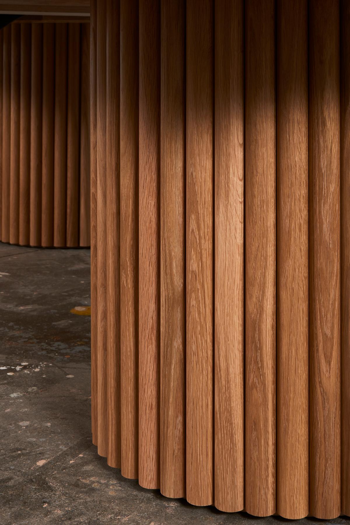 D'une audace inouïe, la table à manger de Kate Duncan est une pièce qui rend hommage à la fois à l'esthétique contemporaine et à l'architecture brutaliste. De grandes colonnes de cannelures cooptées et un plateau en bois massif massif créent une
