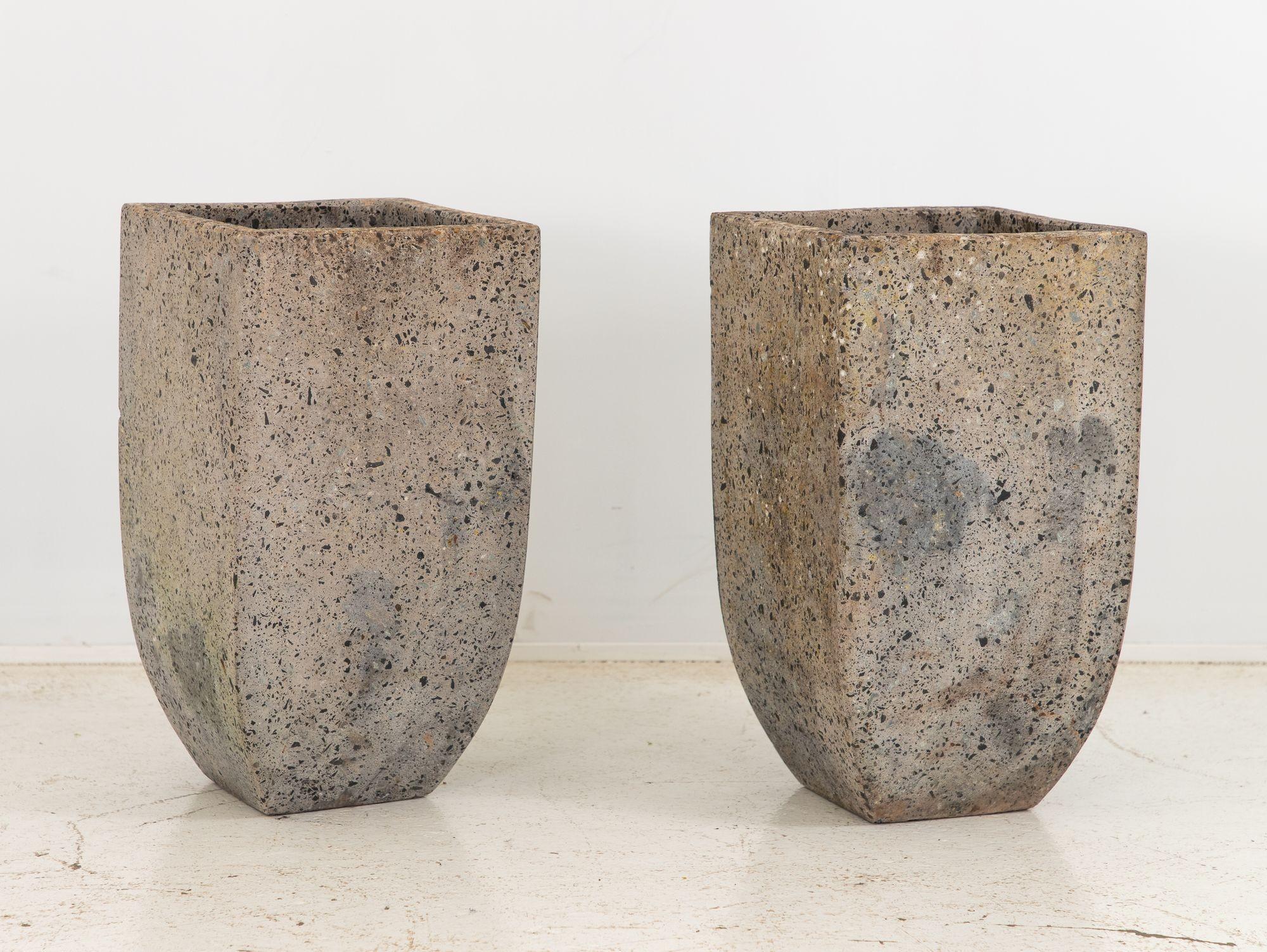 This striking pair of large planters draws inspiration from the bold aesthetics of Brutalist design. Crafted with a fusion of mixed stone and concrete, these planters showcase a rugged yet refined appeal. The raw textures and irregular shapes evoke