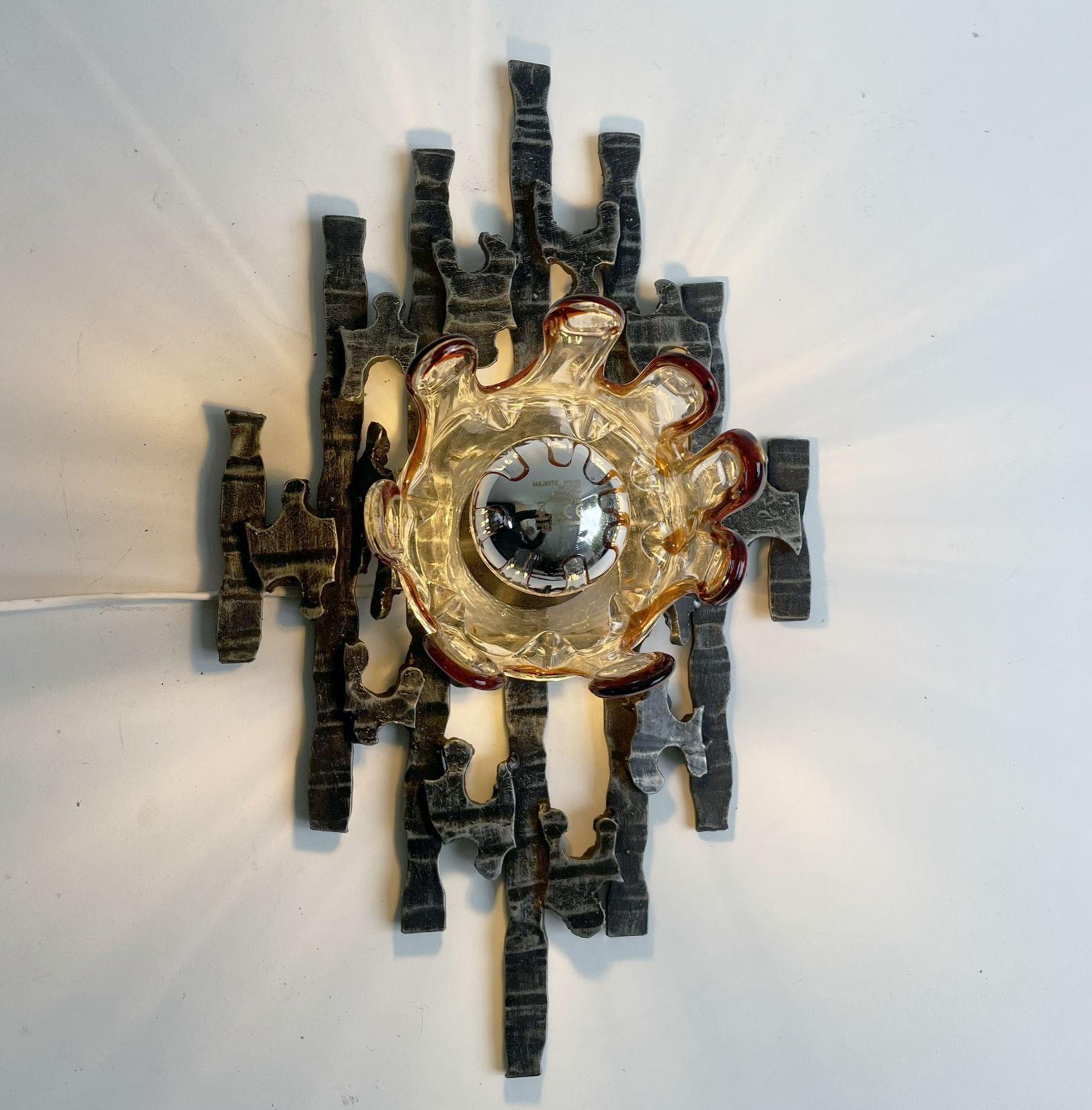 Solid construction made of iron and Murano glass. In the manner of Tom Ahlström and Marcello Fantoni.

The lamp will work with European E27 lightbulbs or the American E26 bulb. Works with old filament bulbs or LED filament bulbs, 220V for Europe and