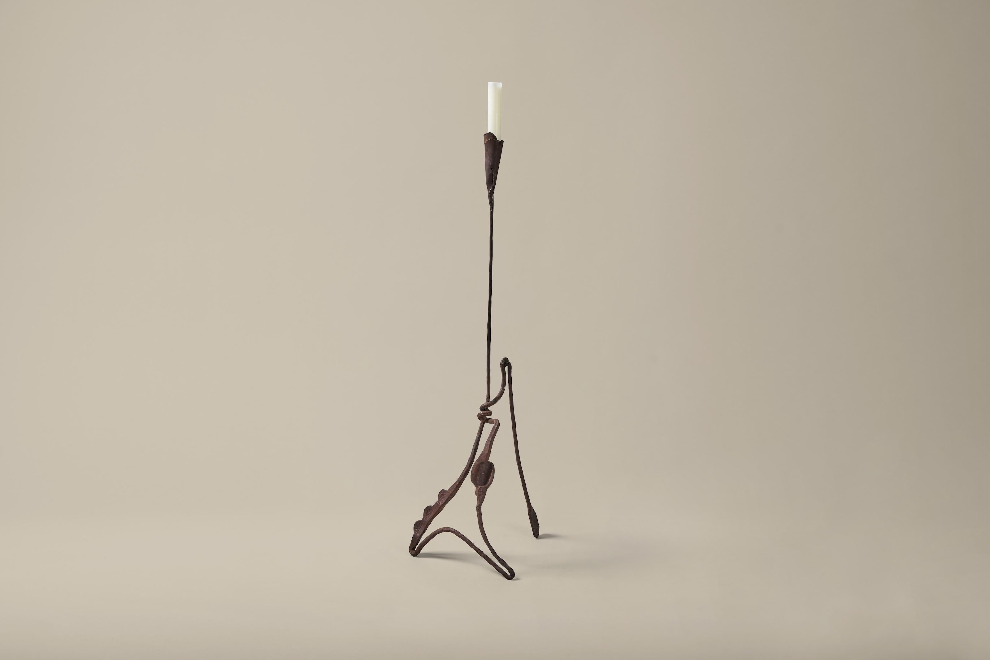 This sculptural iron candelabra holds a single candle. The raw, roughly hewn texture is characteristic of Brutalist design. Slightly higher than four feet tall, the piece is a statement-making accent for any space.

Measures 17