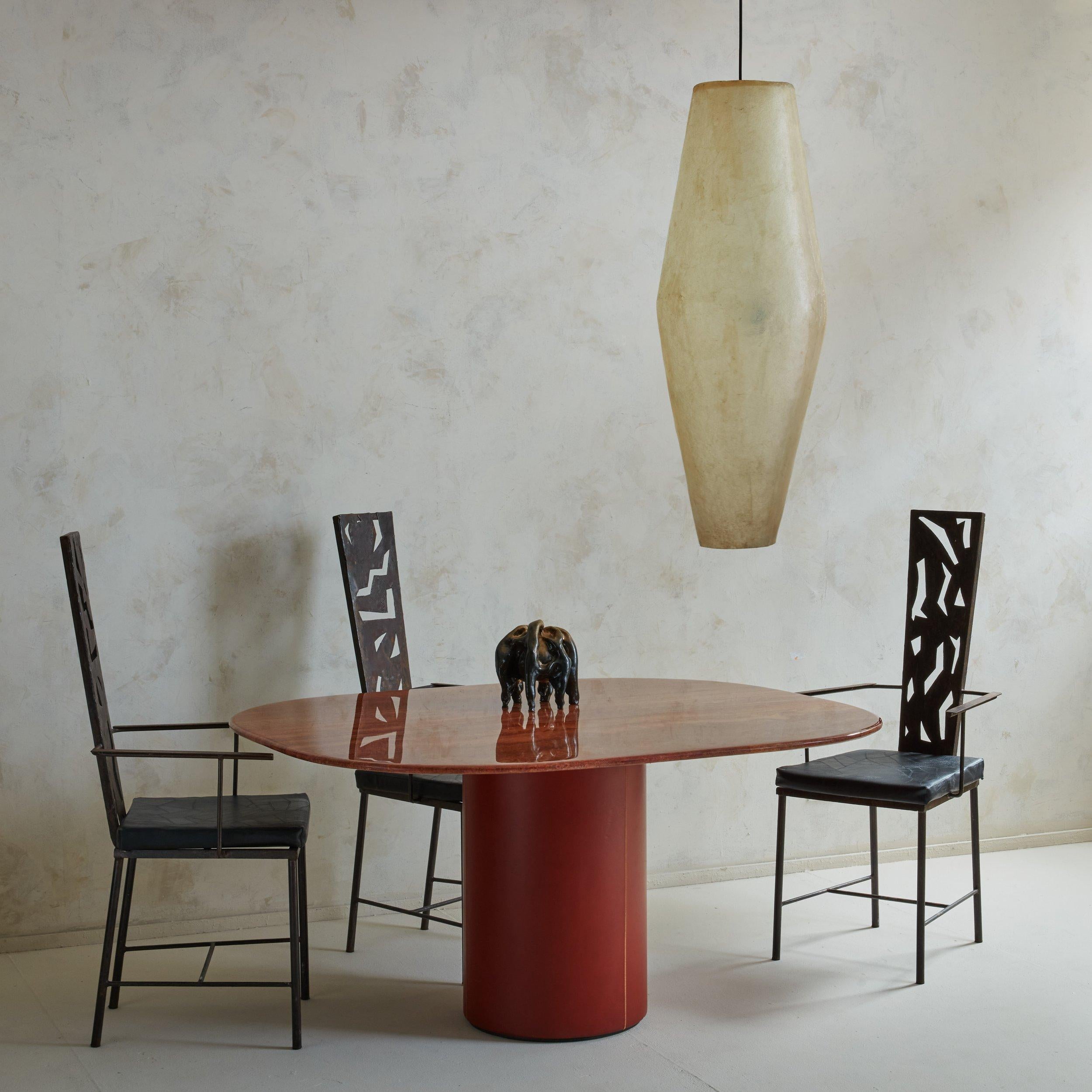 Sold and priced individually.

A beautiful and unique welded iron Brutalist chair featuring negative space geometric abstract shapes on the backrest and a black leather removable cushion.

Brutalism is an architectural current, born in the 1950s in