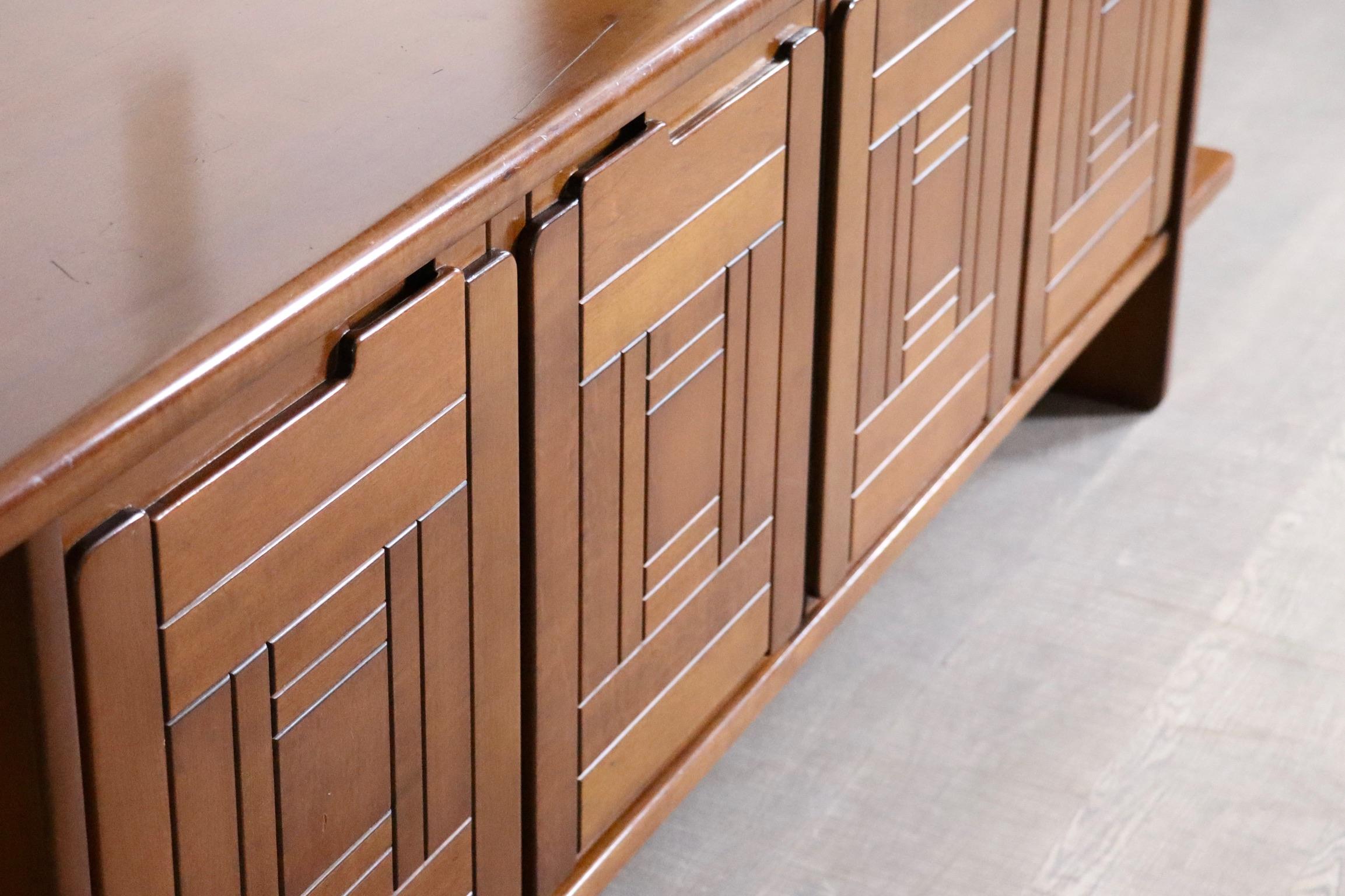 This sideboard is a real standout piece when it comes to craftsmanship. The doors feature a bold, graphic design that adds texture and rhythm to the front. Made from rich walnut wood, the body has clean lines and smooth, rounded edges, giving it a