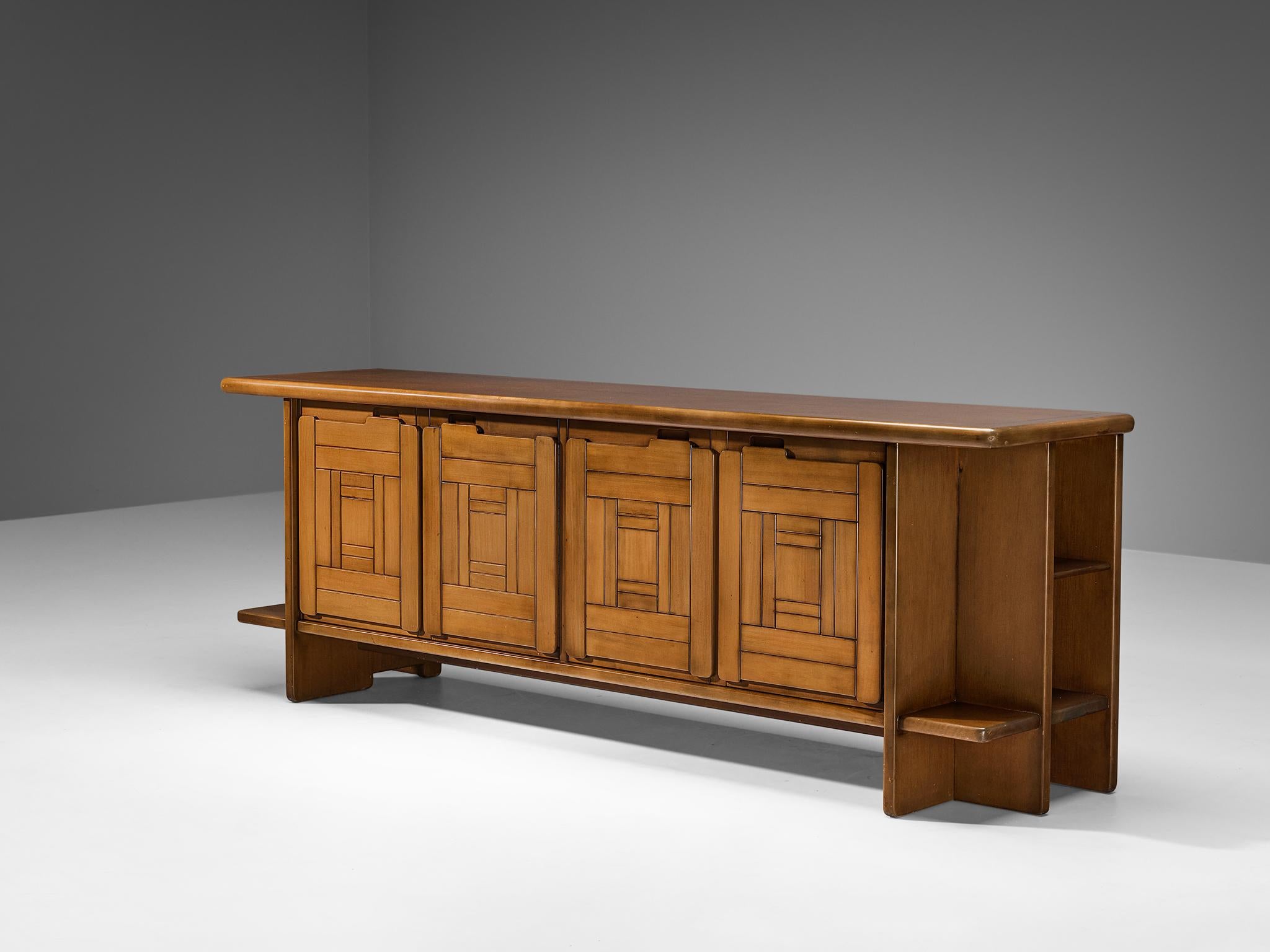 Sideboard, walnut, Italy, 1970s.

This sideboard is a good example of excellent woodworking by virtue of the graphical designed doors adding a wonderful rhythmic and haptic surface to the front. The design of the body which is executed in walnut