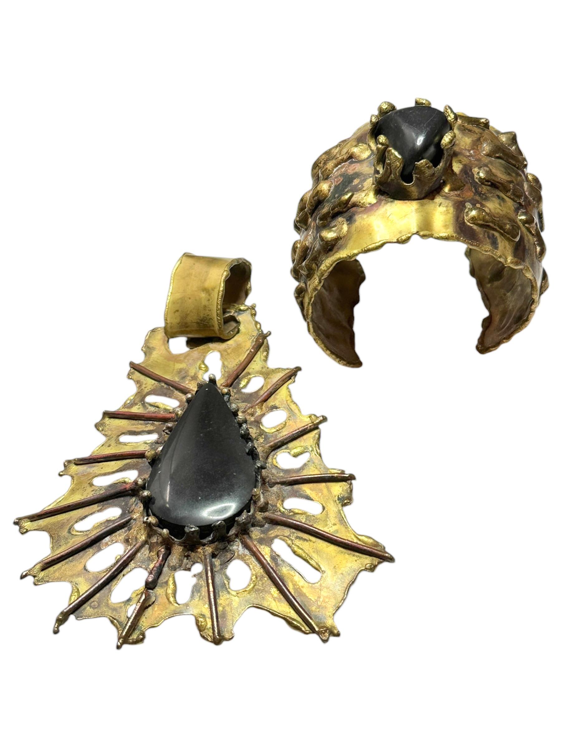 Two Statement mid century studio modernist brutalist made jewelry pieces. A large pendant and a bracelet made of brass and copper with a black stone. Made probably in the Scandinavian Area, because as we were told it was purchased in Sweden by the