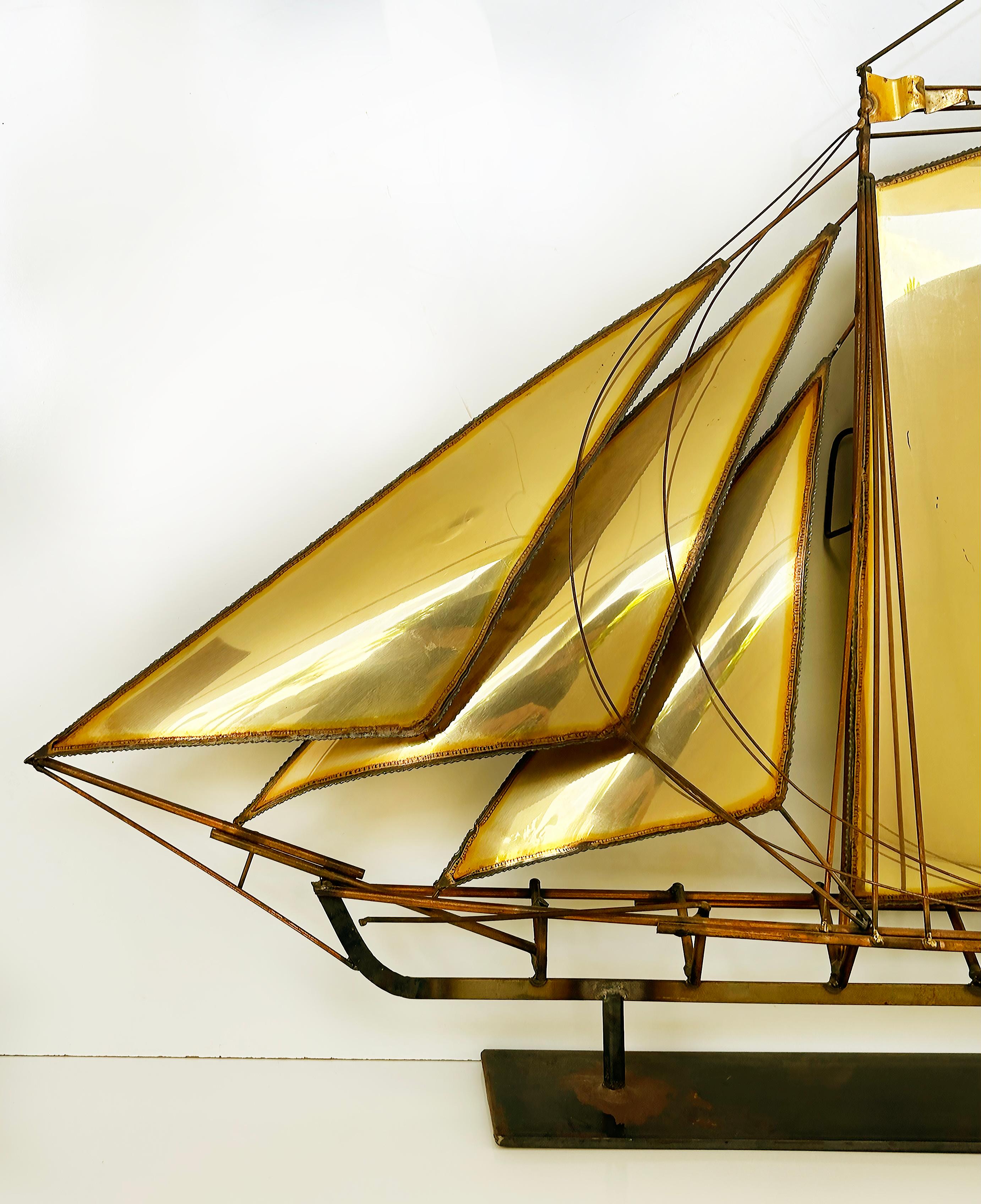 Brutalist John DeMott Large Sailboat Brass Sculpture Wall Sculpture

Offered for sale is a large and striking standing table-top sailboat nautical sculpture by the California artist John DeMott (1954-). The sculpture is in brass and can be viewed