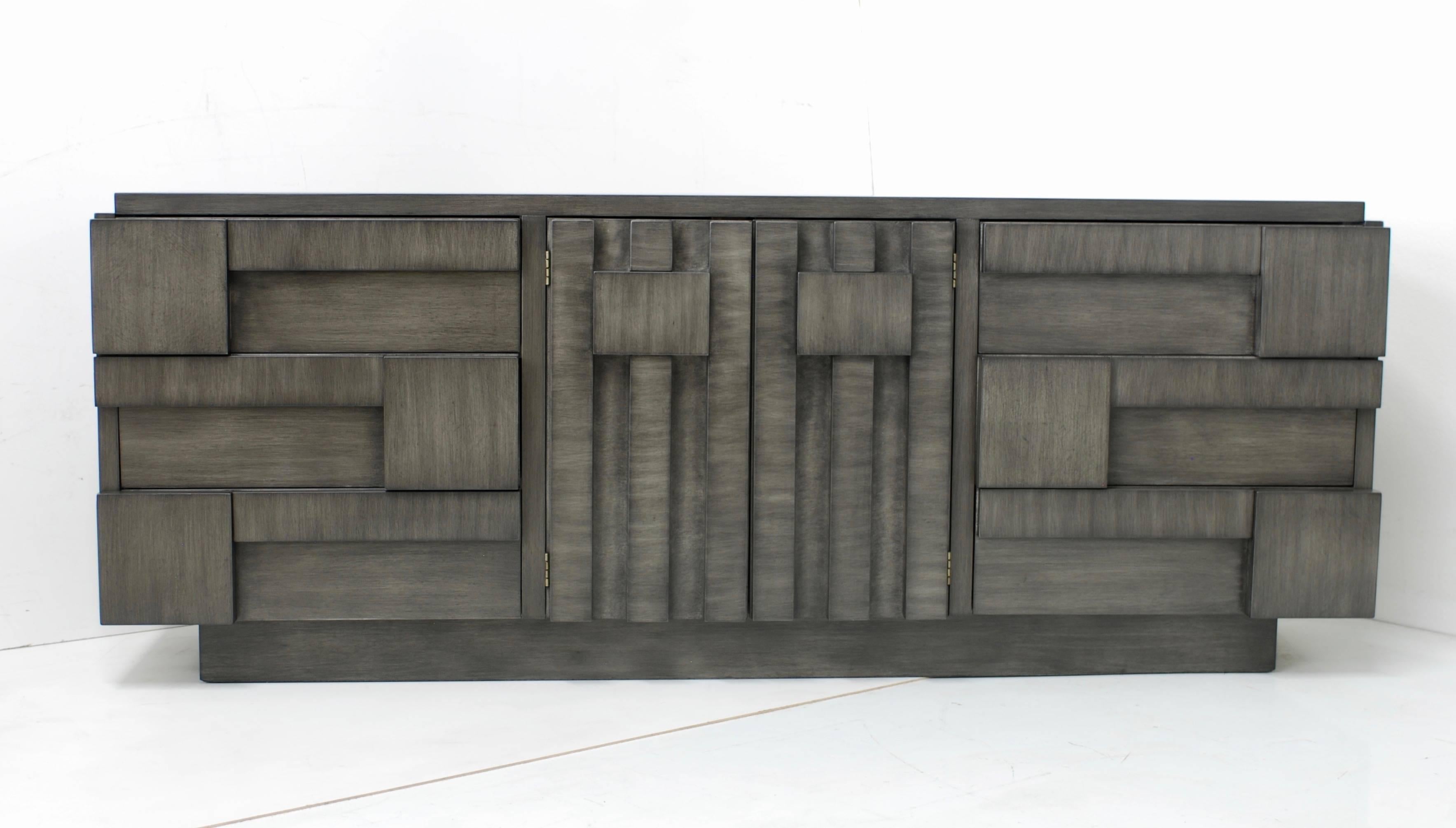 This 'Mosaic' line midcentury Brutalist cabinet or dresser manufactured by Lane has been refinished in a charcoal grey finish. The finish has a grey undertone with a brushed stain on top to give it dimension and depth. There are three drawers on the