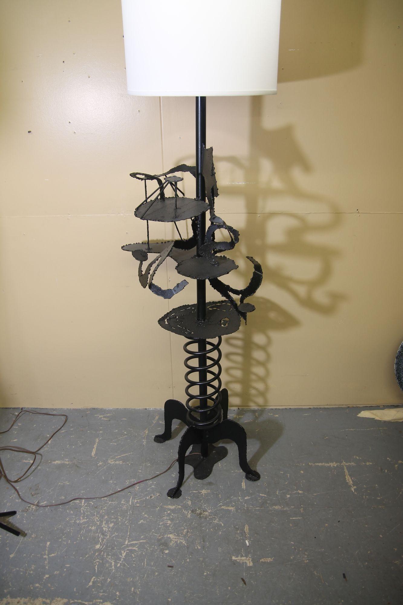 Oversized, brutalist style floor lamp that was artist made. This lamp is assembled with various cut metal, oversized spring and metal pipe. Its a true statment piece.