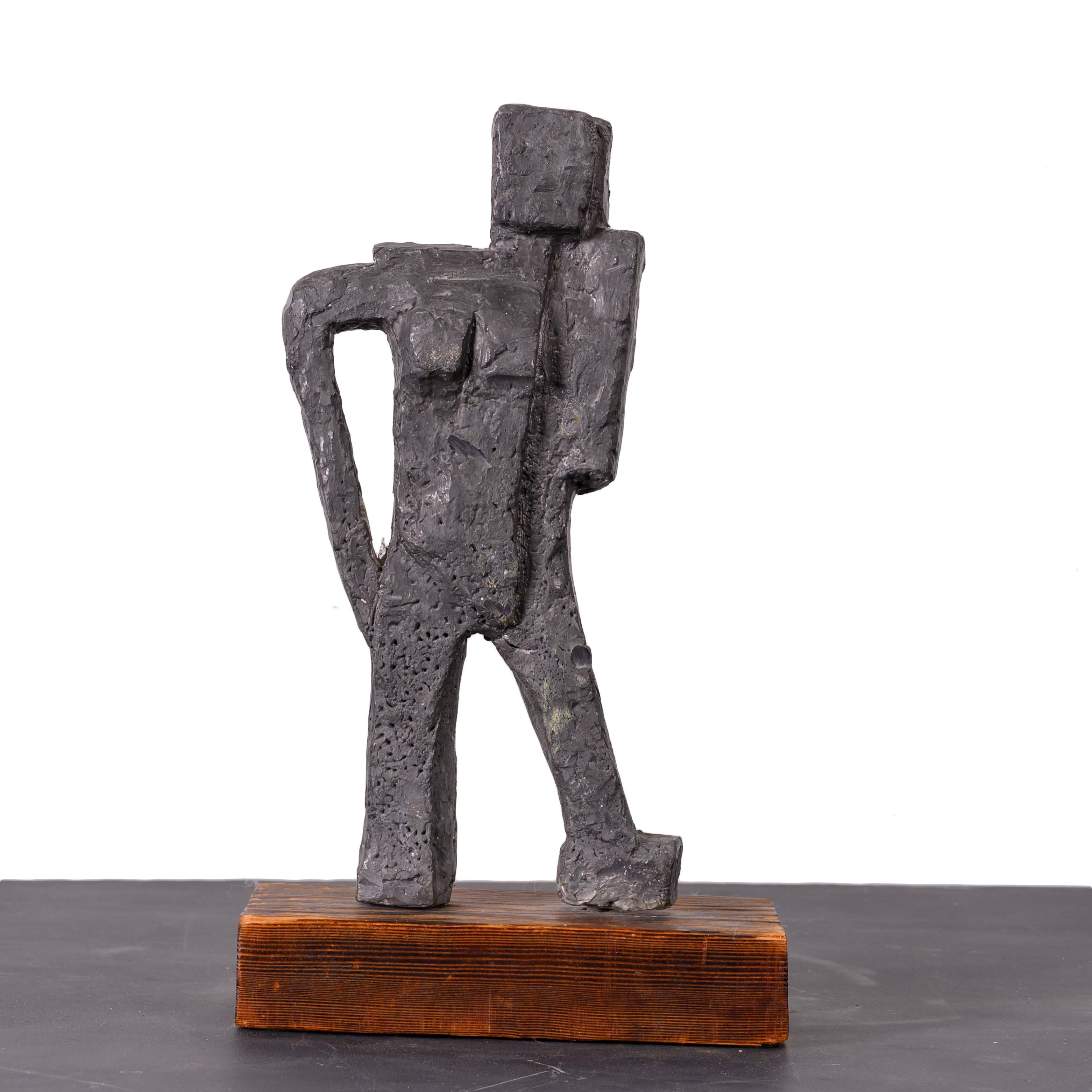A brutalist lead figural sculpture on pine base.

7 ¼ inches wide by 4 ½ inches deep by 14 ¼ inches tall