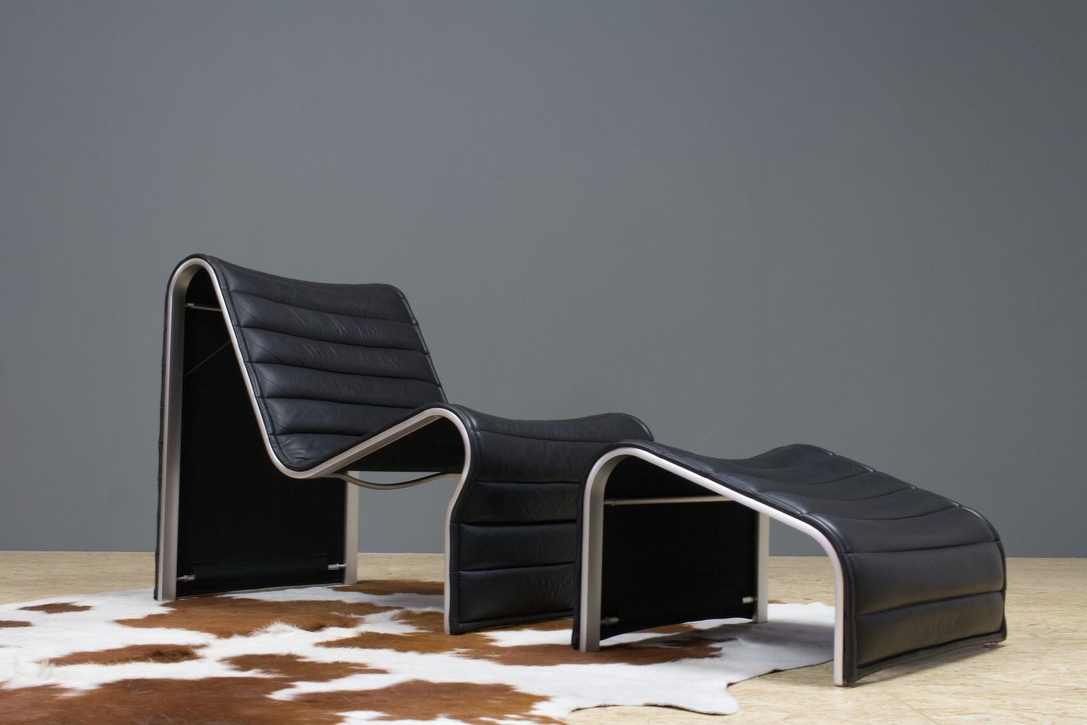 Vintage Swedish 1970s Brutalist leather lounge chair with ottoman, designed by Eric Sigfrid Persson and produced by Möbelkultur AB. The set is executed in a soft, high quality black leather and aluminium frame. The set is in very good condition with