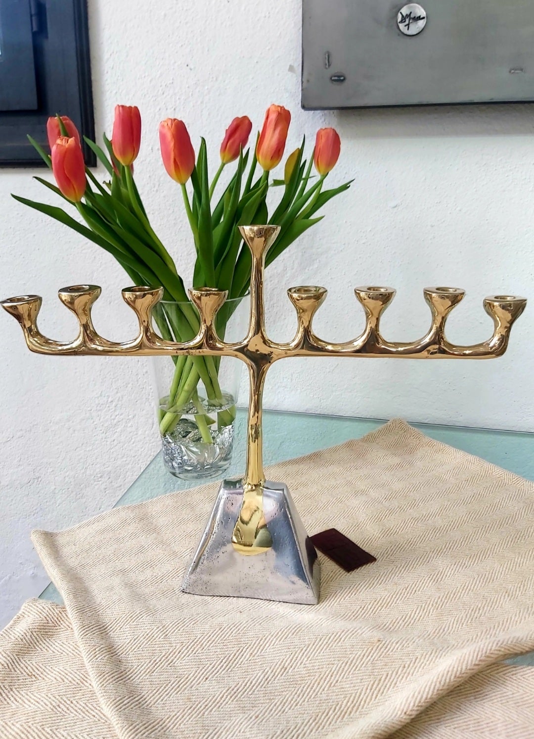 The candelabra was created by David Marshall, from sand cast aluminium and brass.
 We use recycled materials all our pieces are handmade, mounted and finished in our foundry and workshop in Spain.
It is certified authentic by the Artist David