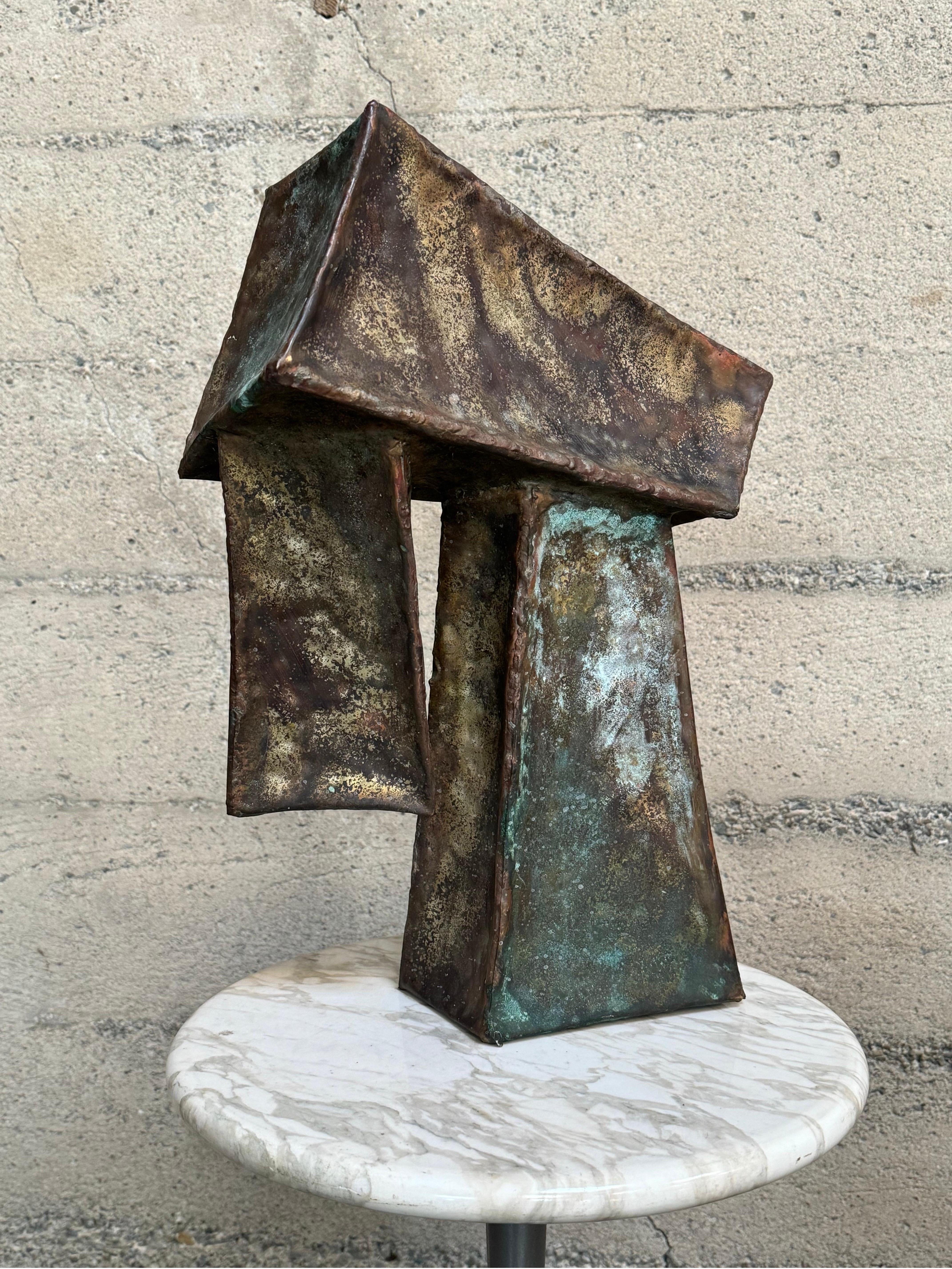 1970s Brutalist abstract sculpture constructed of welded metal with a rich patina to it. Consisting of 3 boxy angular forms welded in opposing angles and directions, there is texture to the metal surface along with contrasting colors to the patina,