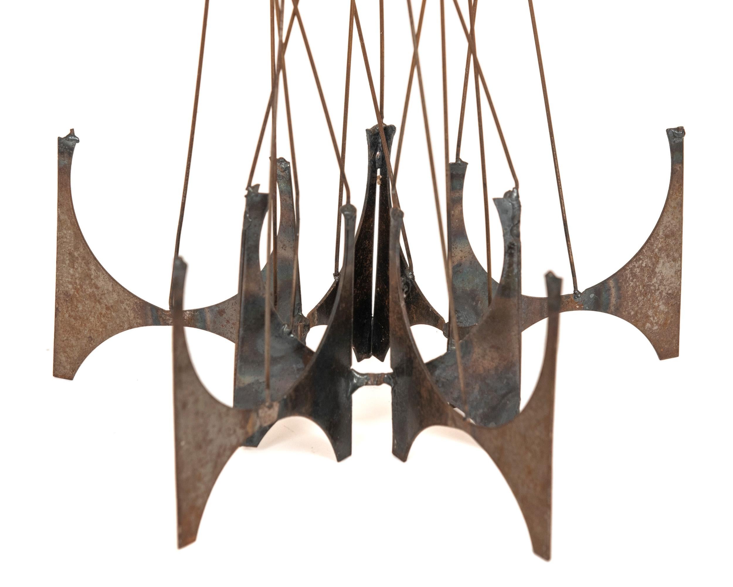 An open and graceful abstract Brutalist sculpture in welded metal with 