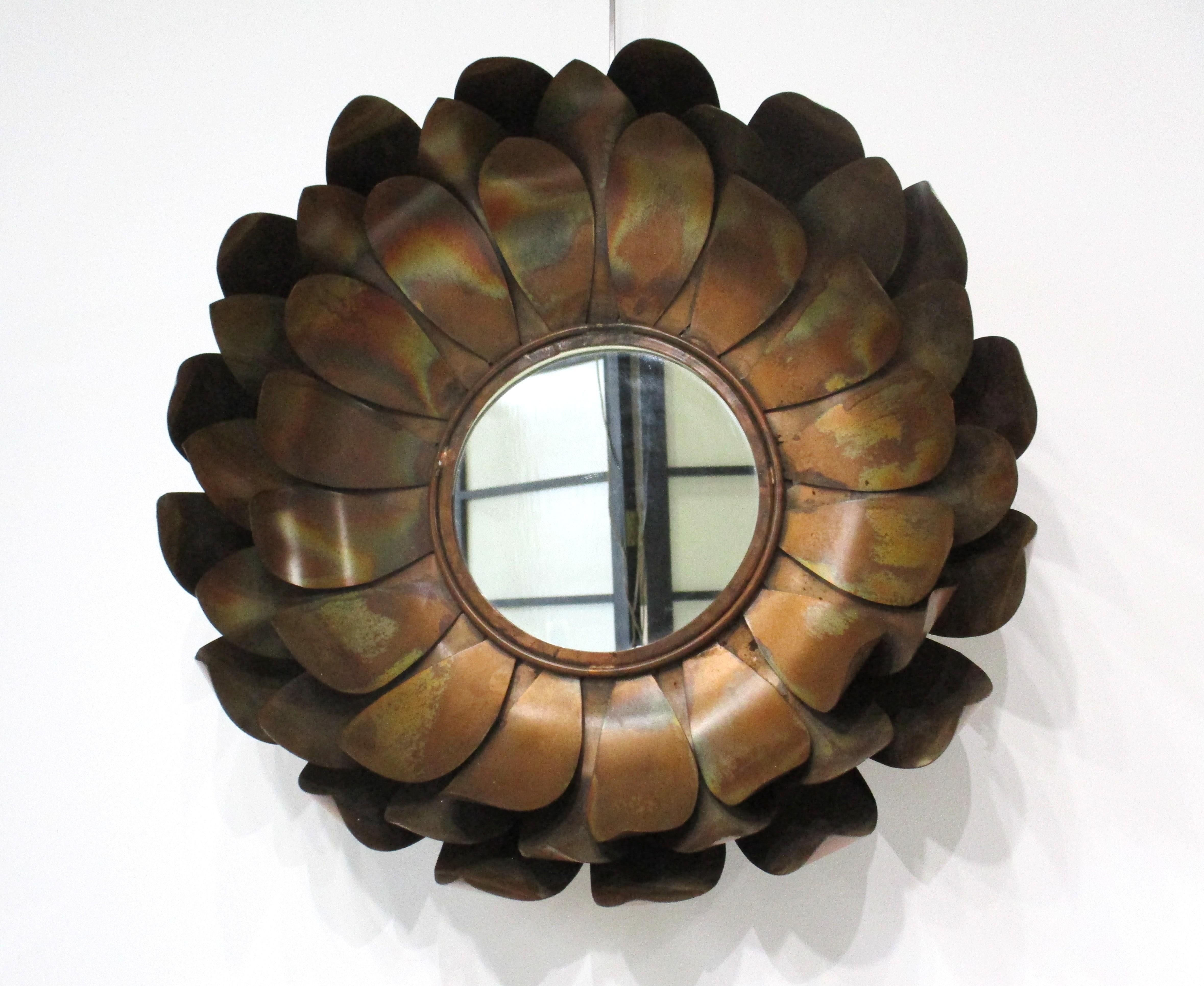 A unique copper metal sculptural flower wall mirror with small 9.25