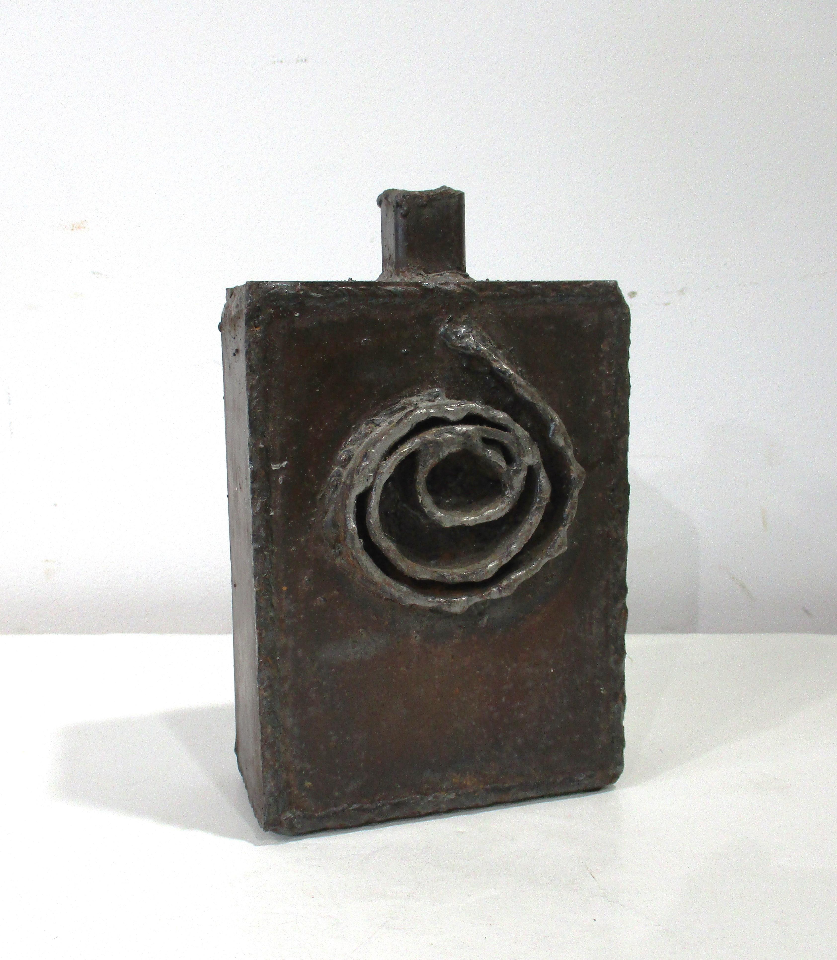 A welded steel box vase sculpture with flamed metal decoration to the body and applied designs to each side . Made in the manner of Paul Evans with highlighted edges to the design in a lighter toned metal applique in the Brutalist style . Signed to