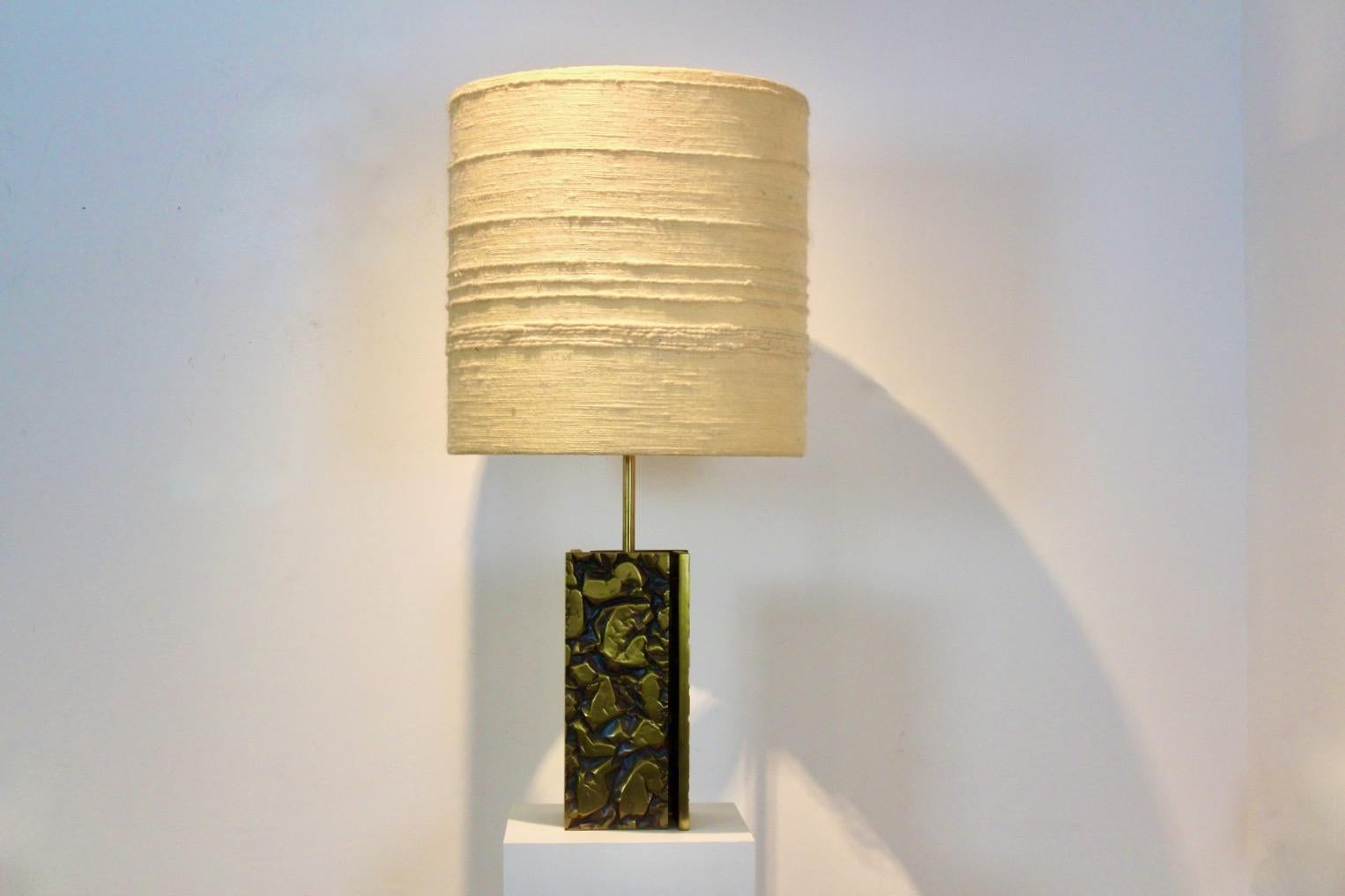 Expressive Brutalist Table lamp made in France in the 1970s. Beautiful Heavy and Large lamp base with Bold Abstract Brass Sculptured accents. Comes with a matching original Raw Woolen structured shade. Completely fine original version. Very good