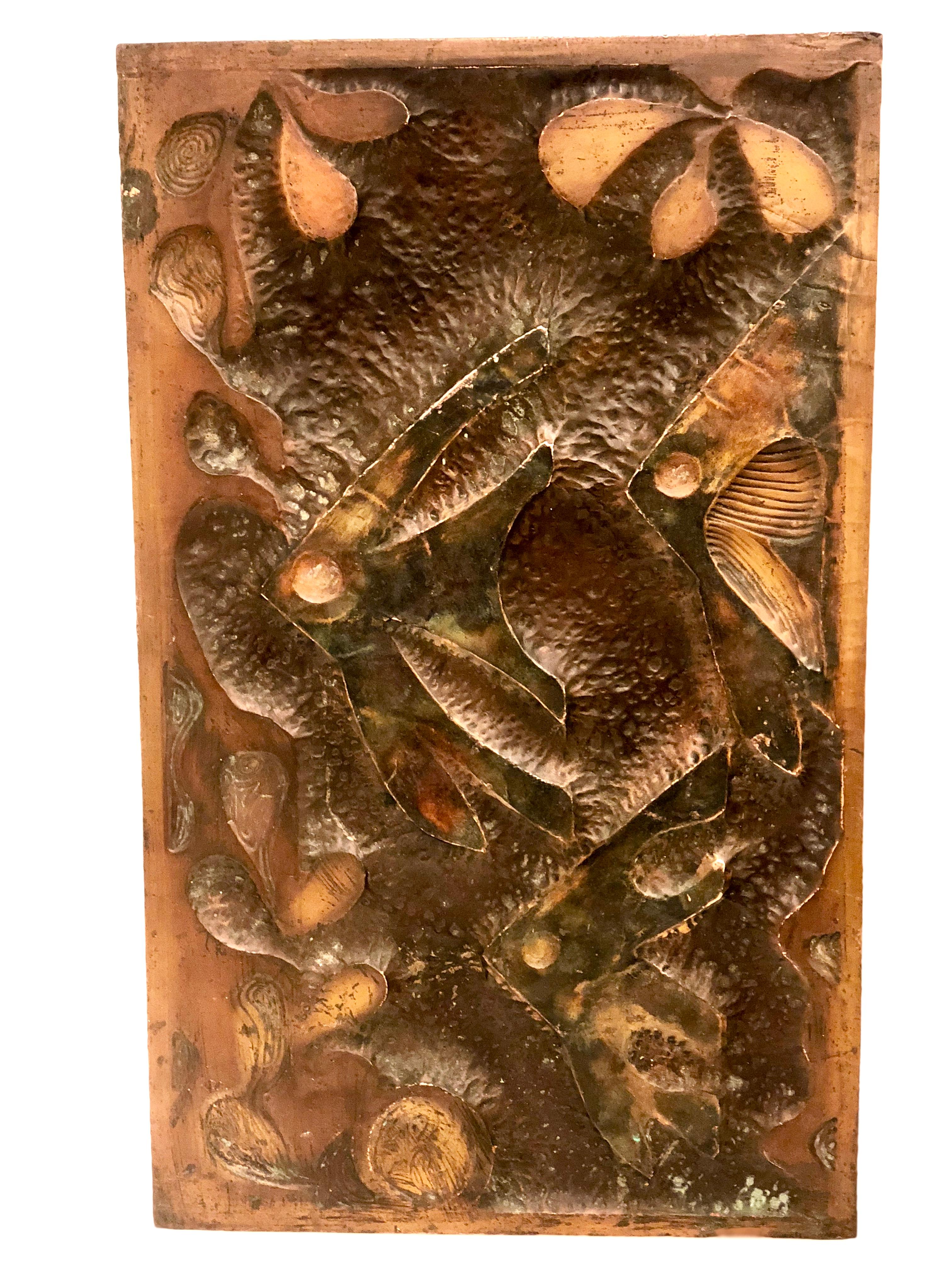 A beautiful and unique copper embossed wall hanging on wood base circa 1970s, can be polished but we left its original patina, with a sea theme and fishes.