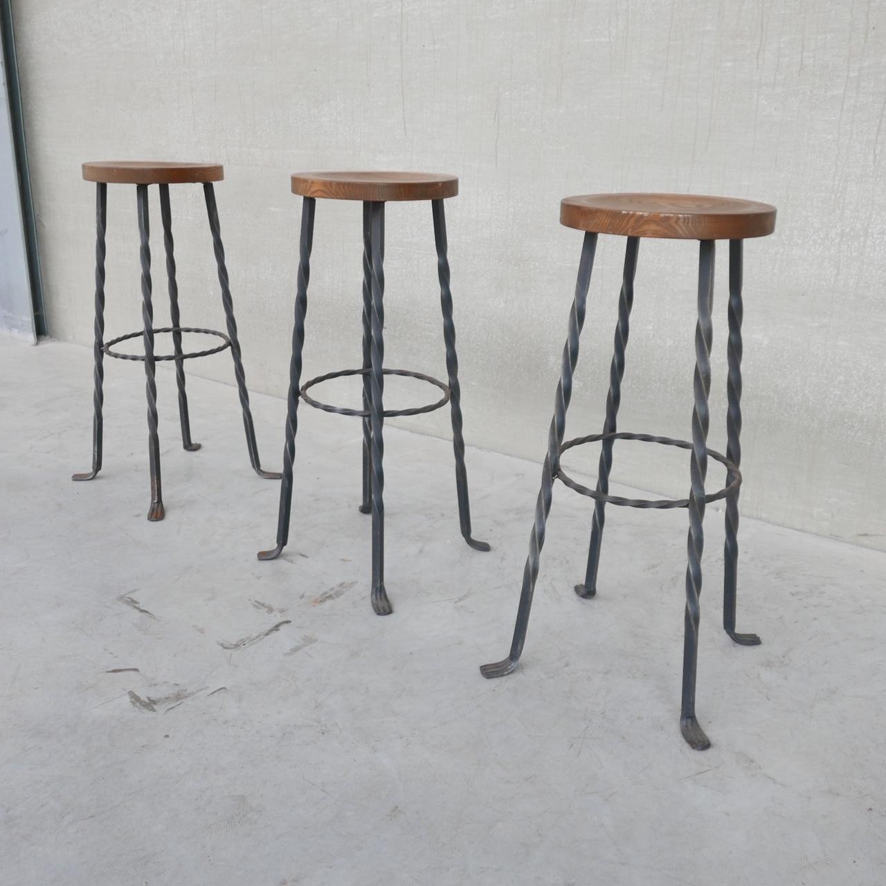 A set of three bar stools. 

Brutalist style, turned iron base with wooden top likely oak. 

Holland, c1960s. 

Price is for the set of three. 

Some small marks to the tops, they could be stripped and refinished. Some light rusting