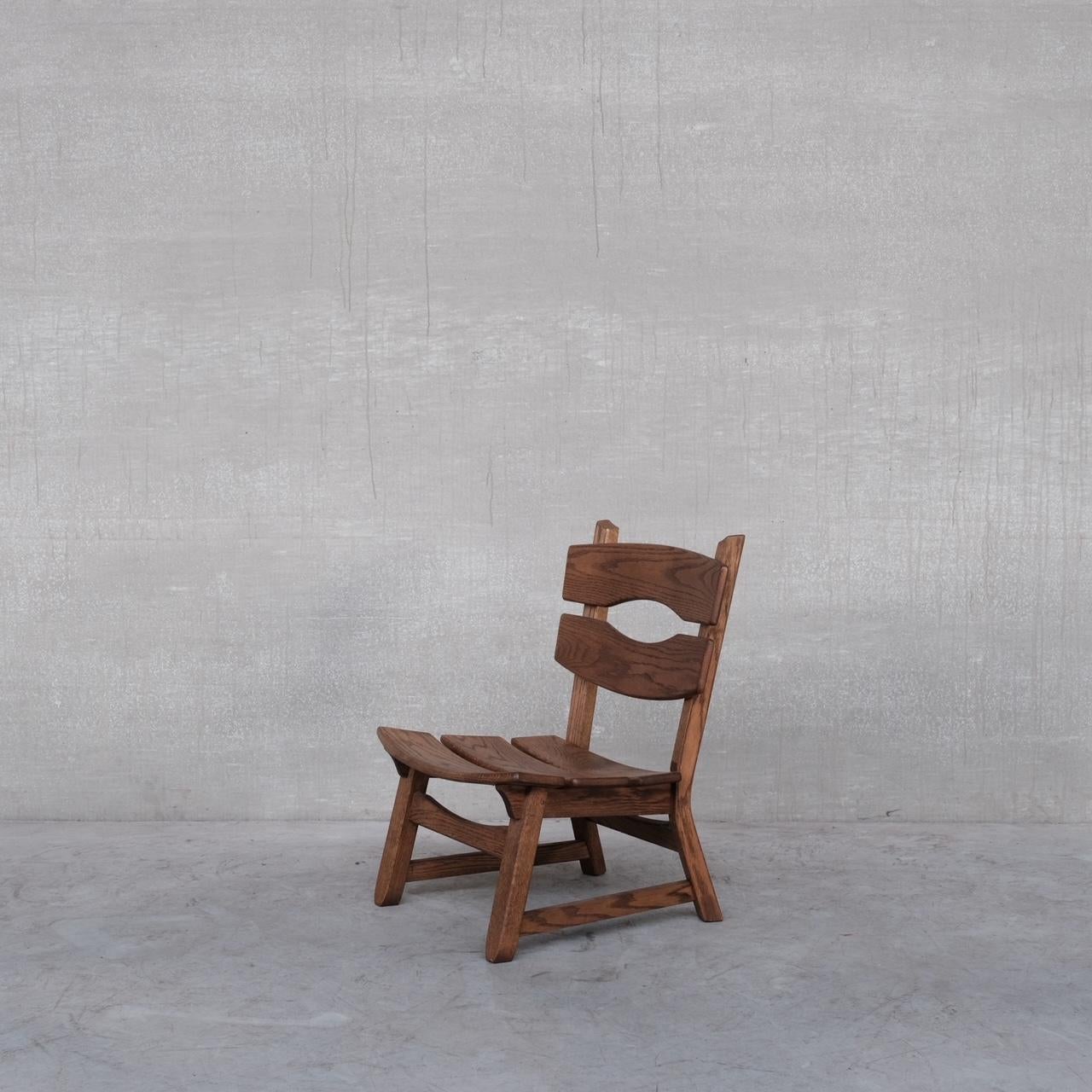 Une série de fauteuils en bois bas. 

Belgique, c1970s. 

Souvent attribué à De Pudyt. 

Malgré le fait qu'ils soient uniquement en bois, ils restent très confortables, ils peuvent être adoucis avec une peau de mouton en bandoulière.