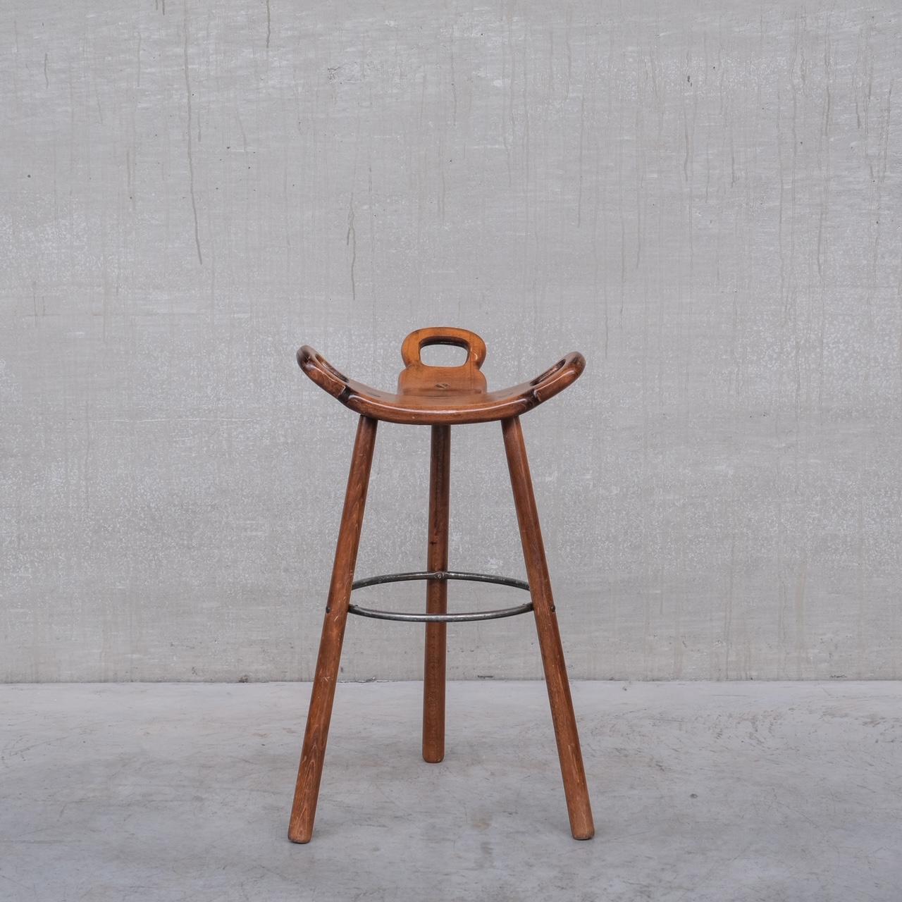 A set of up to six mid-century wooden and iron bar stools. 

Spain, c1970s. 

Likely by Confonorm, Spain. Often attributed to Sergio Rodrigues and Carl Malmsten.

Good vintage condition. Some scuffs and wear commensurate with age. 

Priced