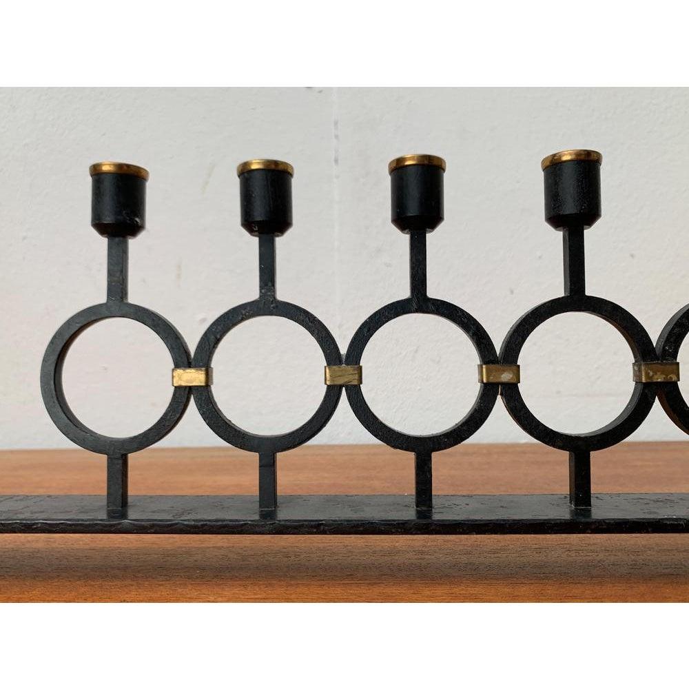 Mid-Century Brutalist Metal Candleholder, 1960s, in Very Good conditions. Designed 1960 to 1969.

Additional information:
Material: Metal
Color: Black
Styles: Brutalist, Mid-Century Modern
Item Type: Vintage, Antique or Pre-owned
Diamension: 19.29ʺW