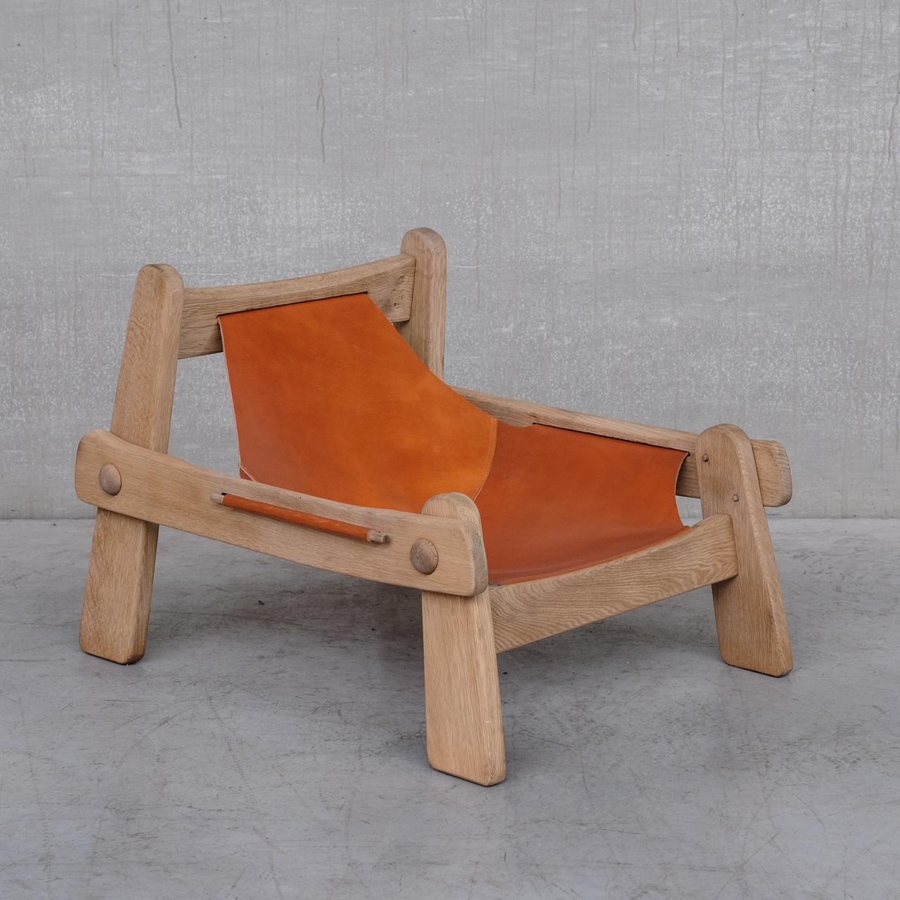 An exceptional leather and bleached oak lounge chair. 

Holland, c1970s. 

A highly recommended clash of brutalist style and a more polished design. 

The leather has been replaced in a poppy orange colour that pitts well with the oak.