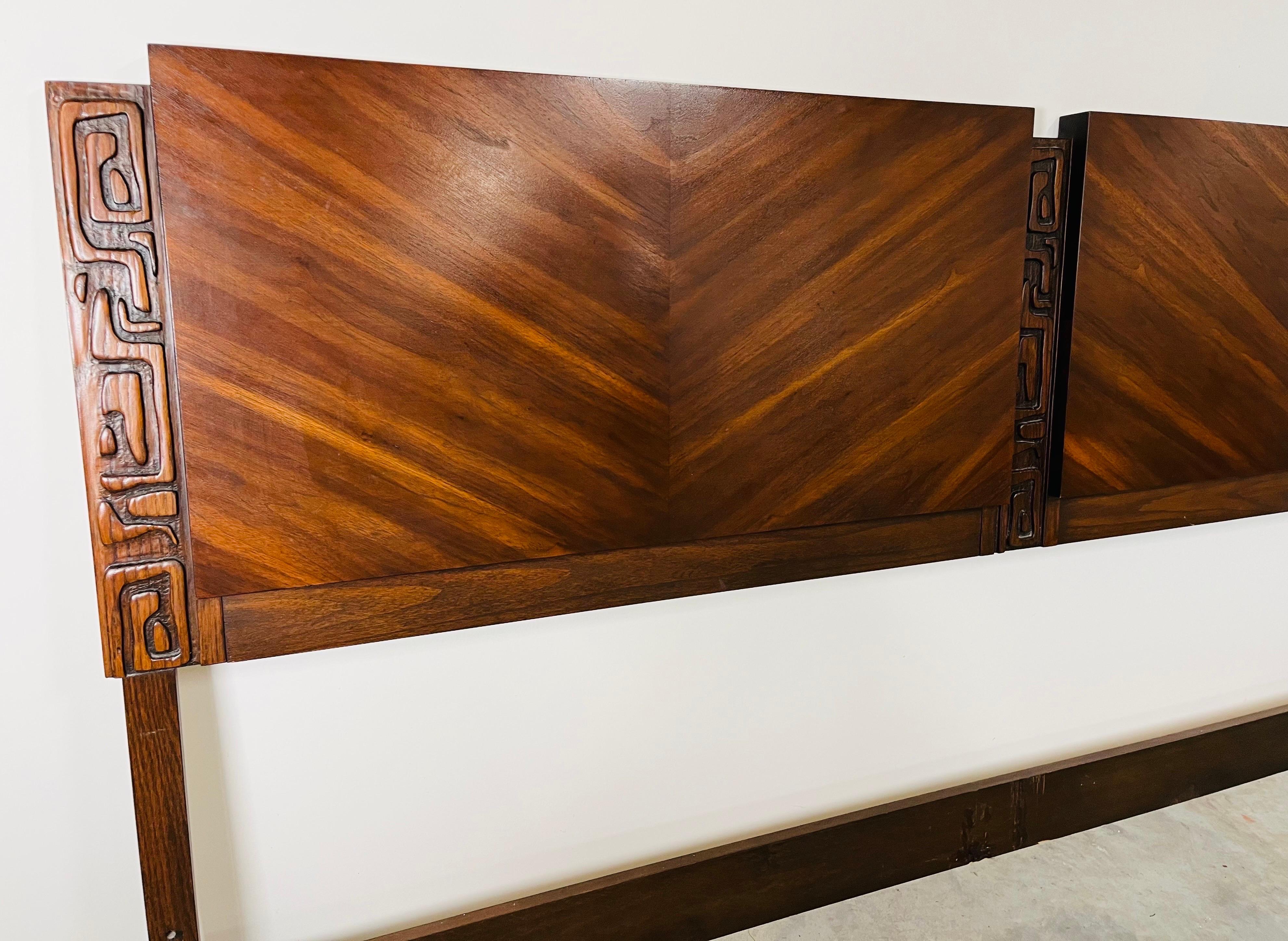 A beautiful Mid-Century modern King size headboard in mahogany having carved tiki patterns that run vertically by United Furniture Co. circa 1960.r In fabulous condition having no damage or scratches. Cleaned and ready for use. 
42.25x80x2” HWD