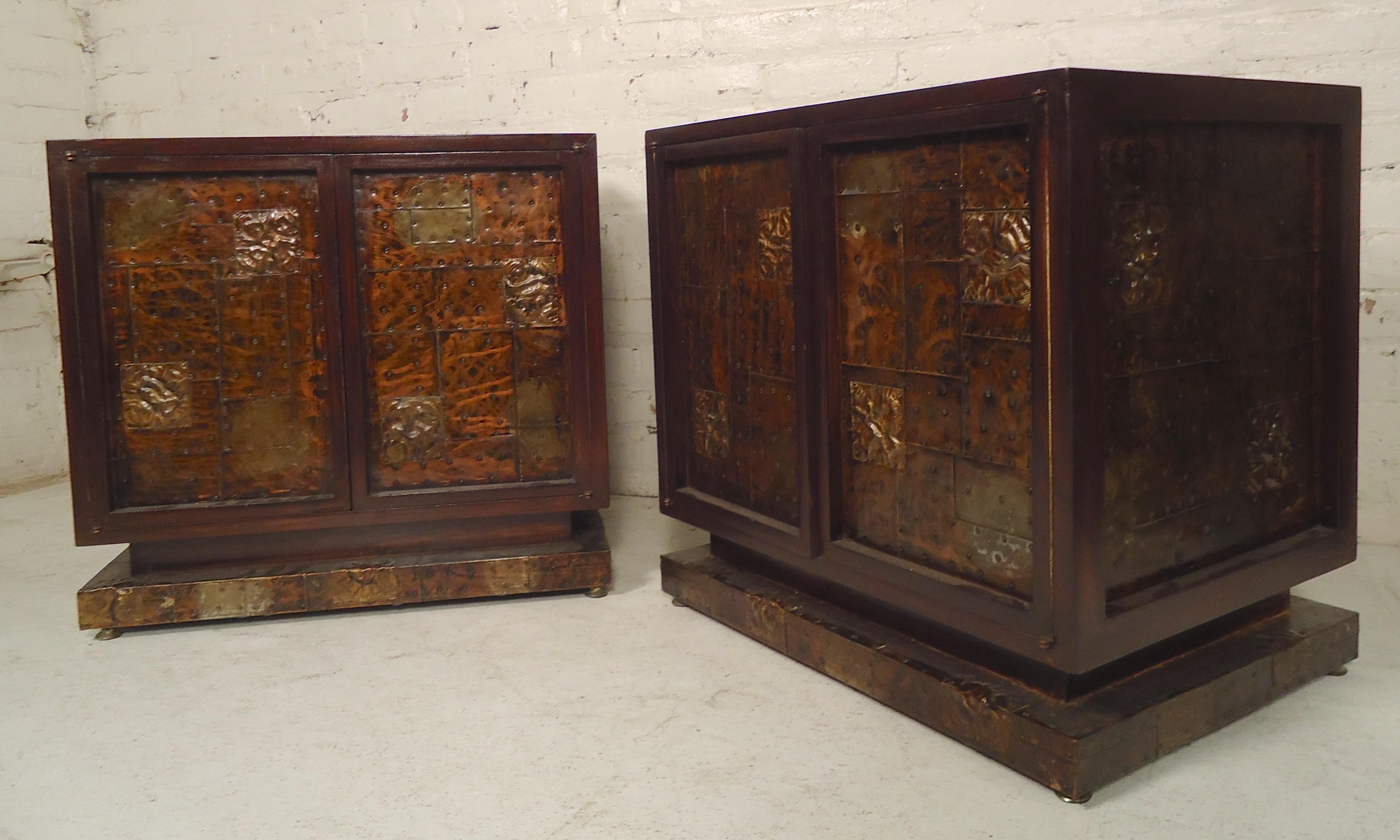 Pair of handsome bedside tables in the style of Paul Evans. Dark mahogany with mixed metal front and sides. Two doors with inside storage.

(Please confirm item location - NY or NJ - with dealer).
 