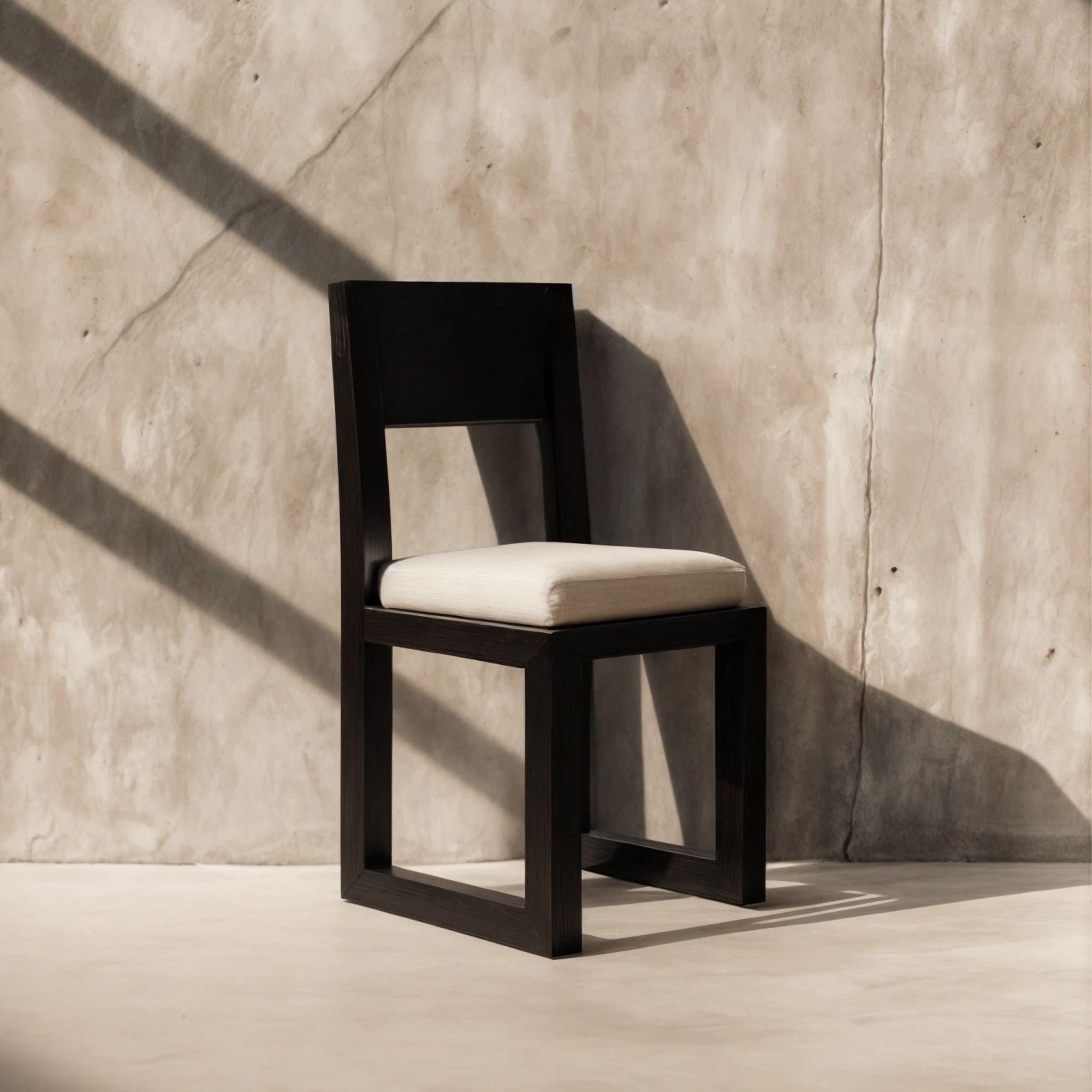 Brutalist Minimal Dining Chair Black Wengue Wood, White Velvet Seat 
The Alva Chair is a stylish black dining chair with a contrasting white upholstered seat. Its dark, solid wood structure reveals its sleek and modern aesthetic, adding depth and