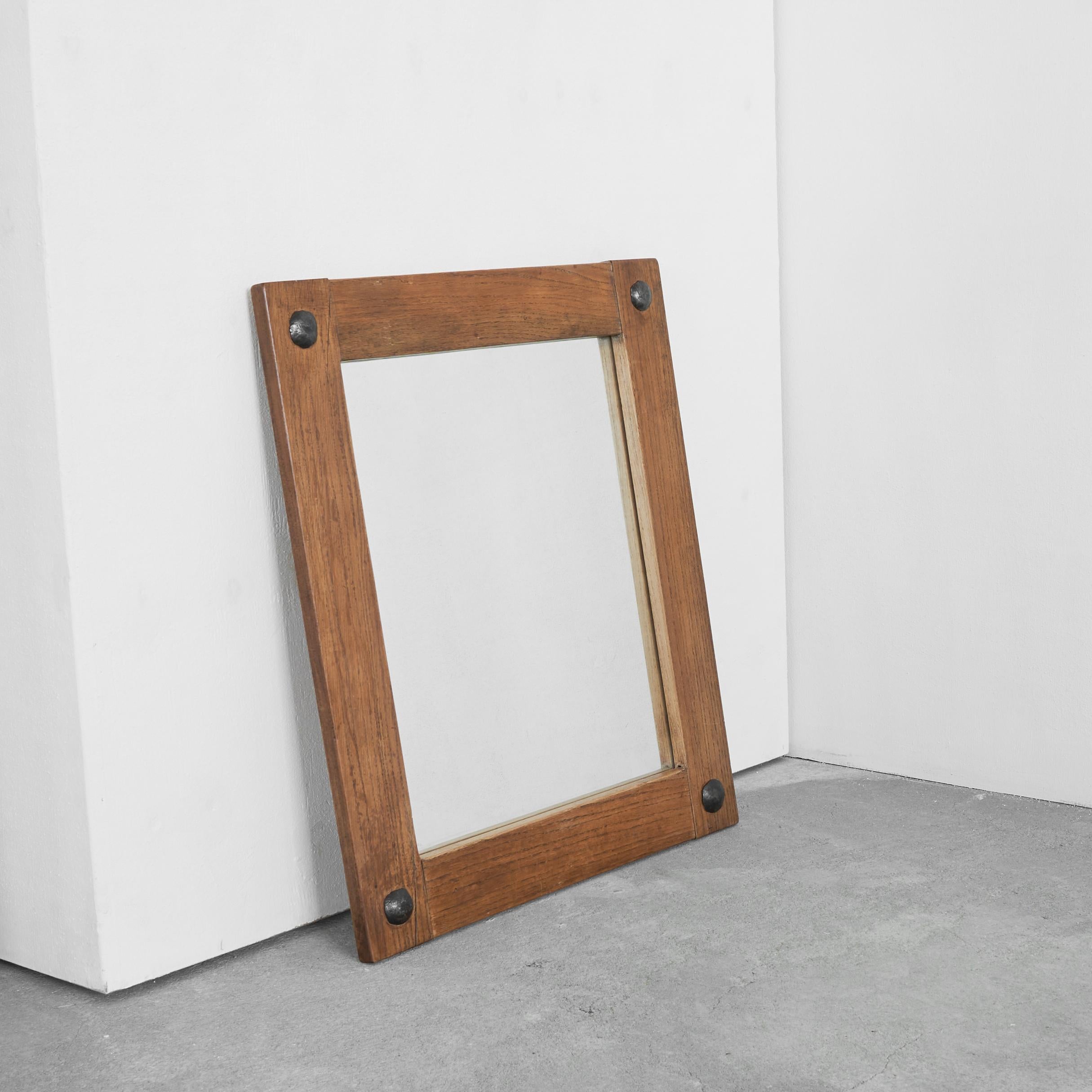 Brutalist Mirror in Solid Oak and Metal 1970s.

Beautiful simple mid-century mirror in solid oak with metal nails. Timeless and elegant, this mirror suits many interior styles. The combination of the solid oak and the metal nails is wonderfully