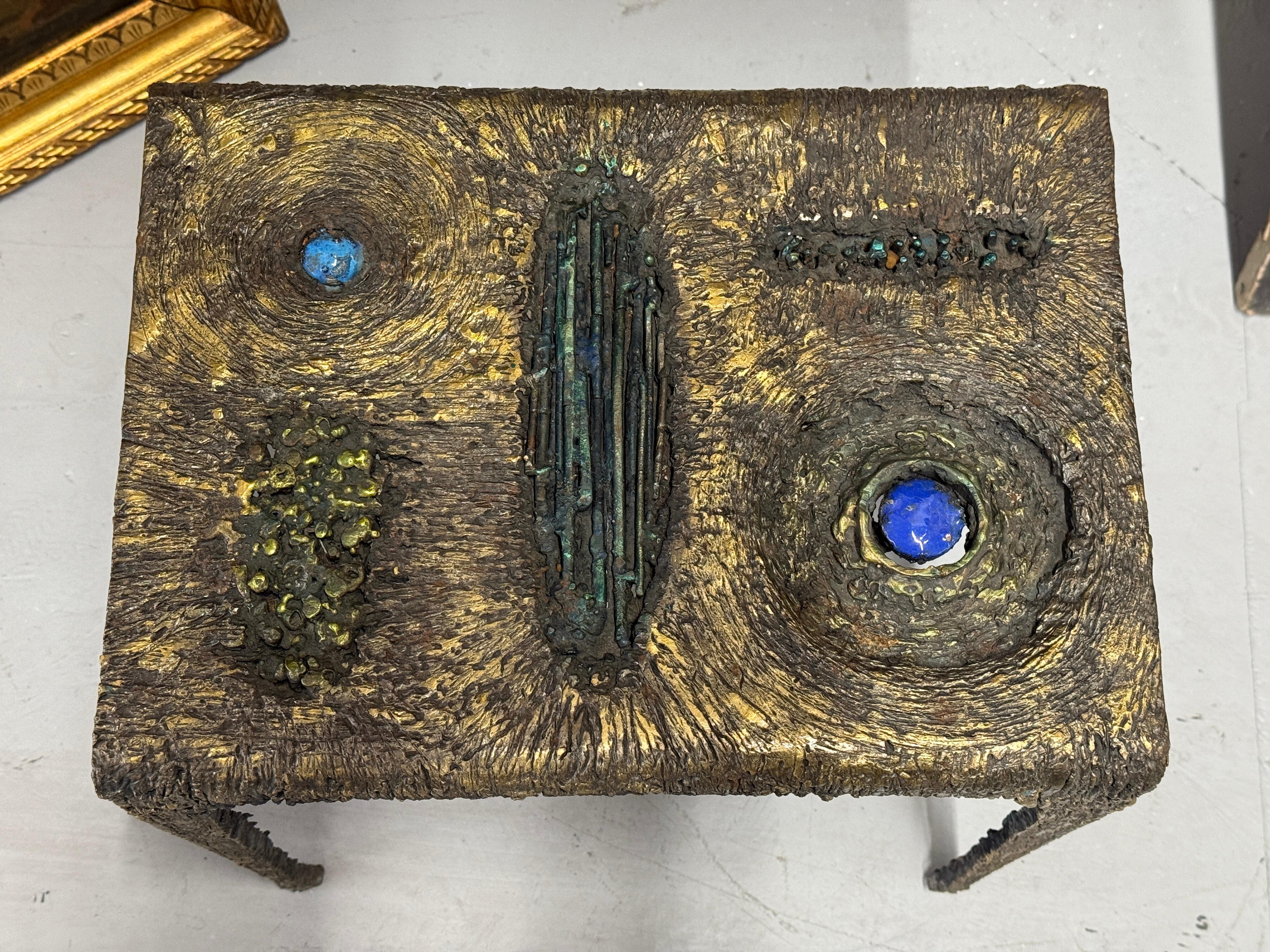 A stunning brutalist table in mixed metals and enamels by the noted Des Moines Iowa artist James Bearden. The table features bronze torch cut steel and enamel. It is an elegant and sculptural accent to any room. Please see it in our gallery pictured
