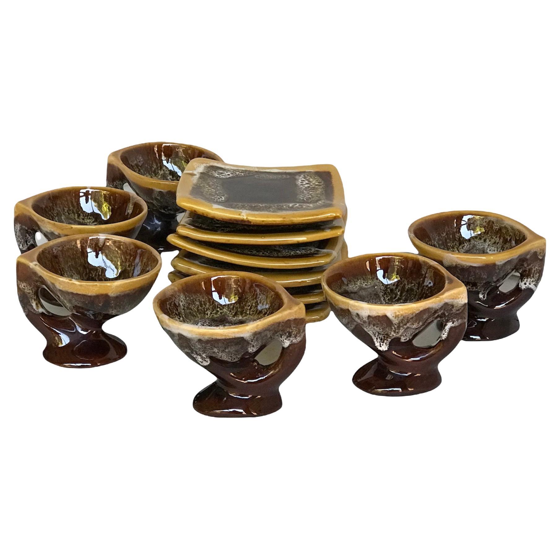 Vallauris France 1950s very modern, Bruatlist or Surreal ceramic Set of 6 Demitasse Cups and Plates. With the typical lava glaze of Vallauris pottery in white glaze dripping over dark brown body with a mustard color rim. The plates do not have the