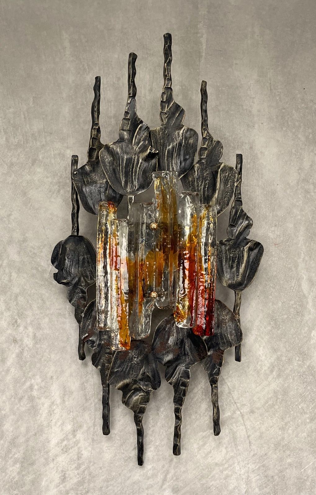 Sculptural Scandinavian Modern Glass Metal Sconce by Tom Ahlstrom Hans Ehrich 1970s - A hand-wrought iron surround holds an amber and clear Murano ice glass - gives a beautiful warm effect when lit. Stunning Swedish industrial design. There are a