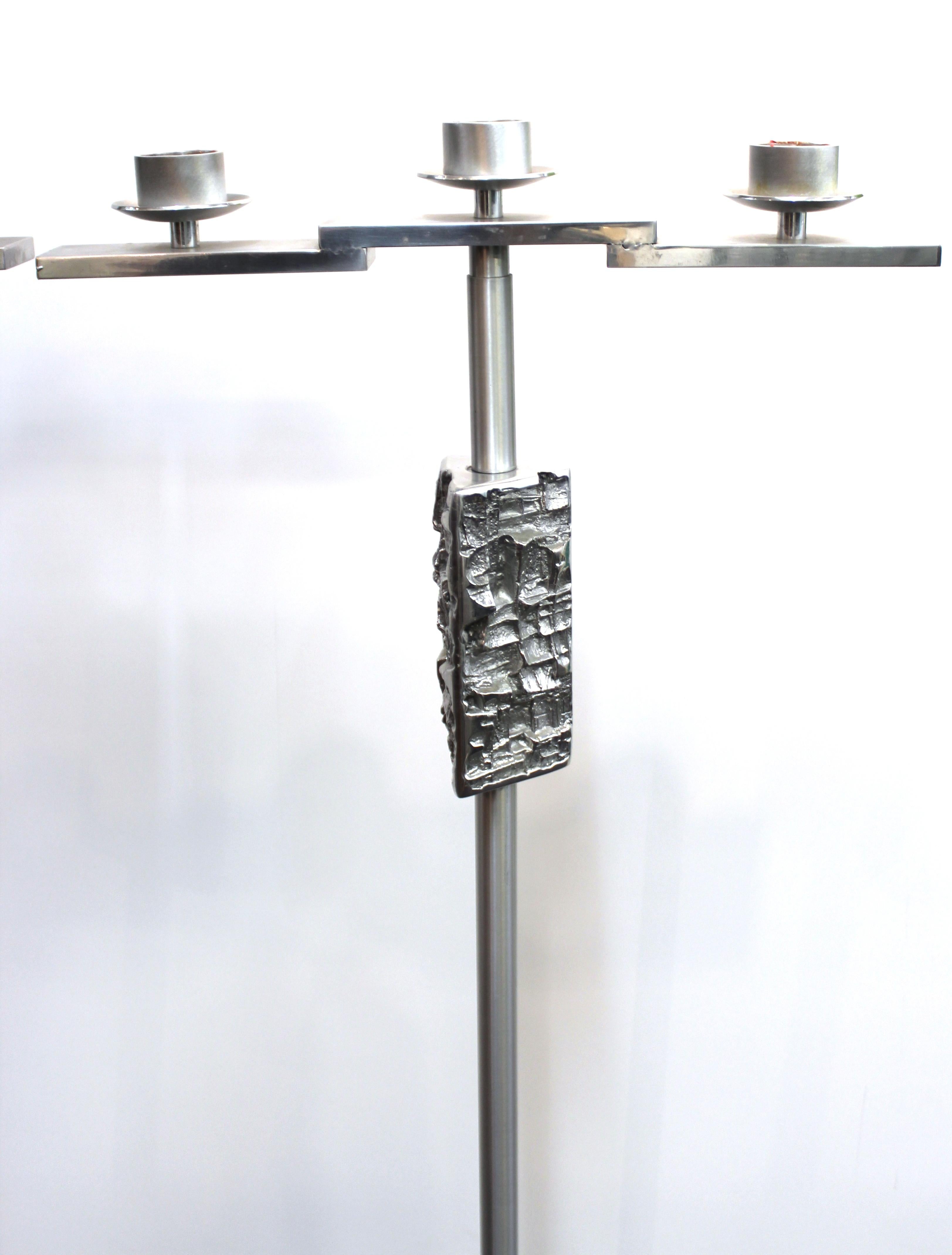 Brutalist modern set of two monumental candelabras, each able to hold three large candles. The pieces feature a Brutalist metal sculpted design on the upper body neck. In great vintage condition with some age-appropriate wear and scratches to the