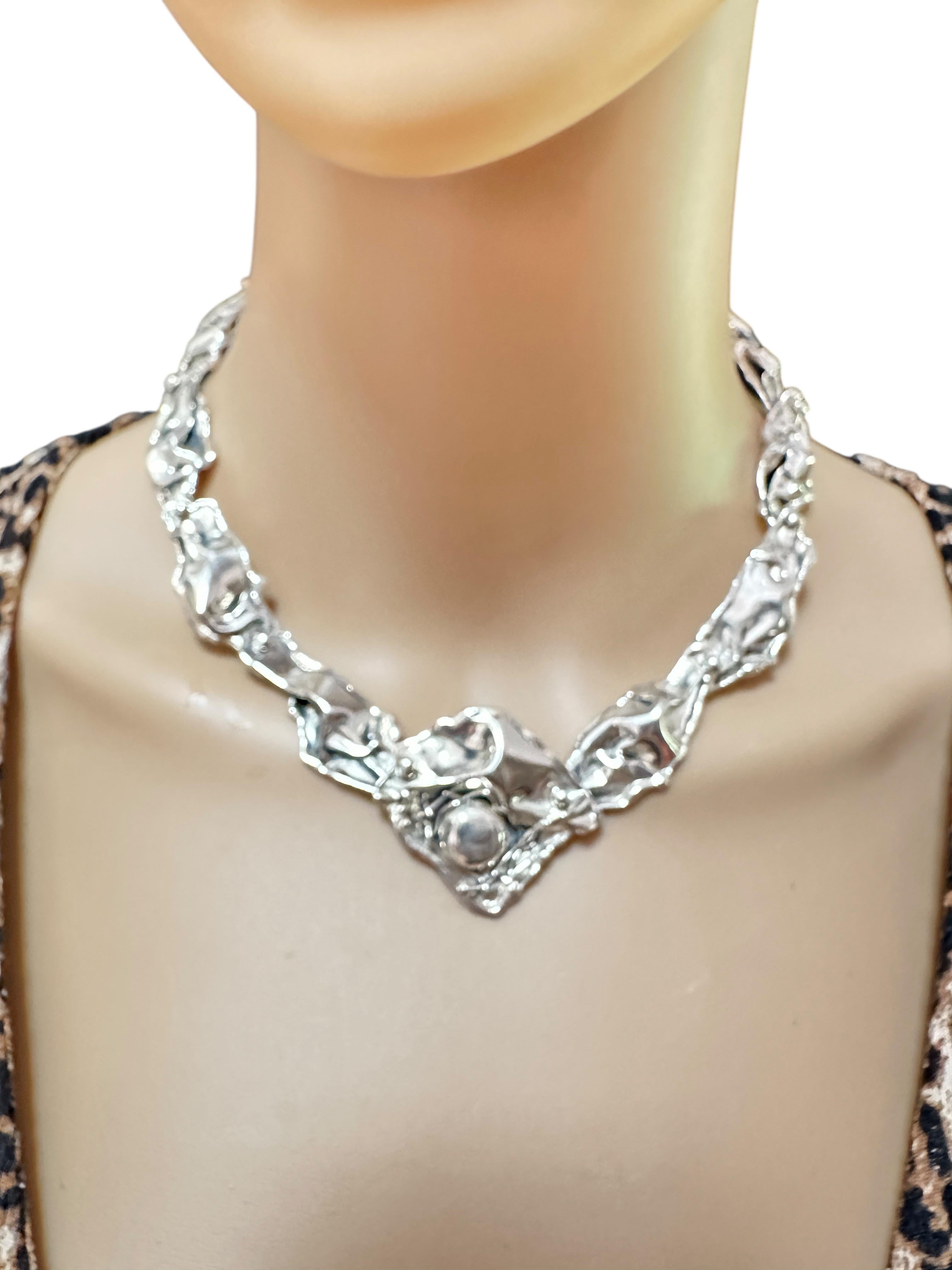 Sterling Silver Petals and Reeds necklace. A very beautiful artisan piece. All hand made with four large petals on each side linked together with hand-made rivets. Width of side petals is a little over 1/2 inch. Total length of front petal is