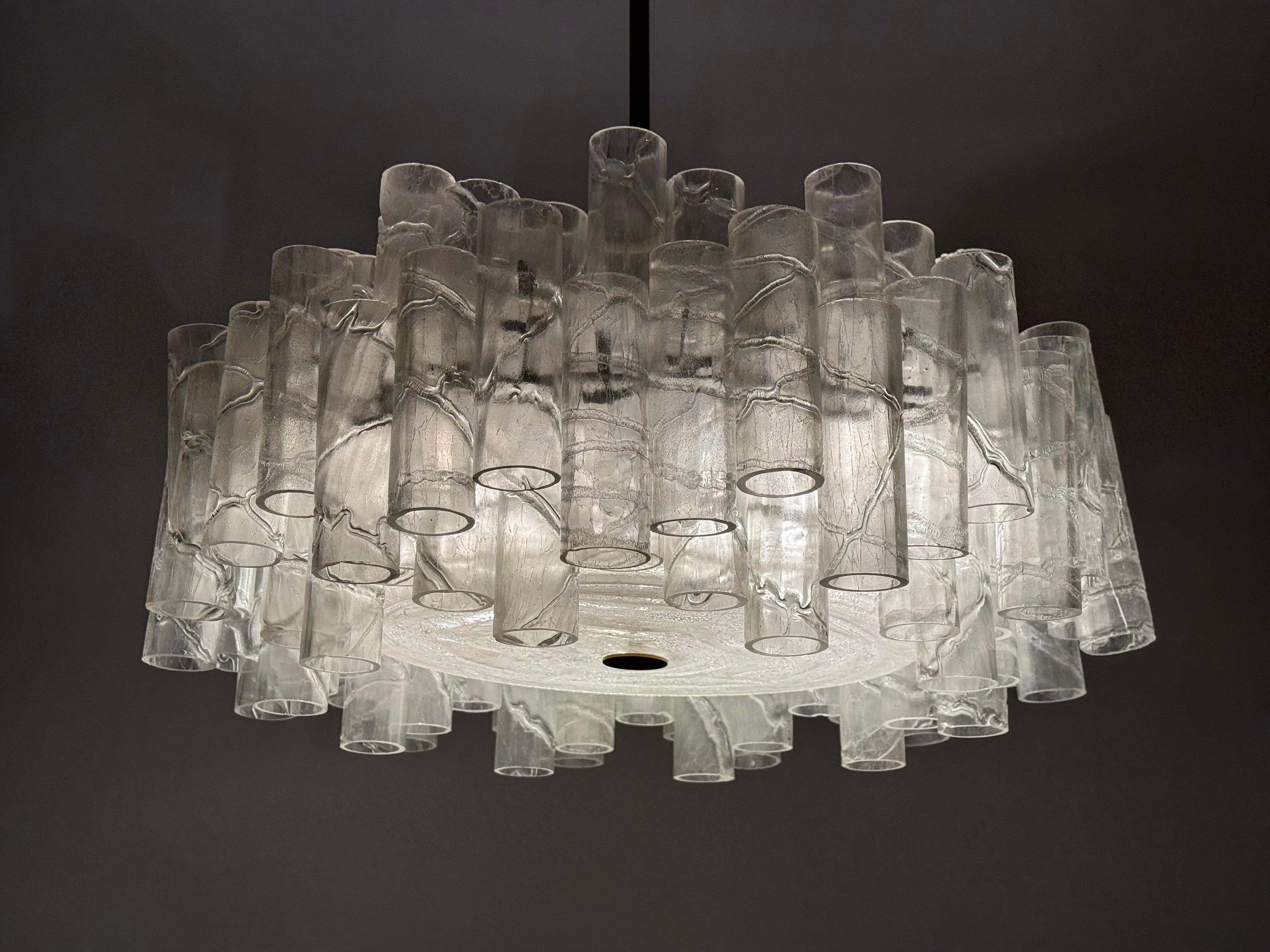 Arguably one of the most exciting and beautiful ice glass tube chandeliers from the Dutch manufacturer Doria Leuchten. 69 Murano glass tubes with a matte finish make this chandelier a unique eye-catcher. The elaborately crafted tubes are mounted at
