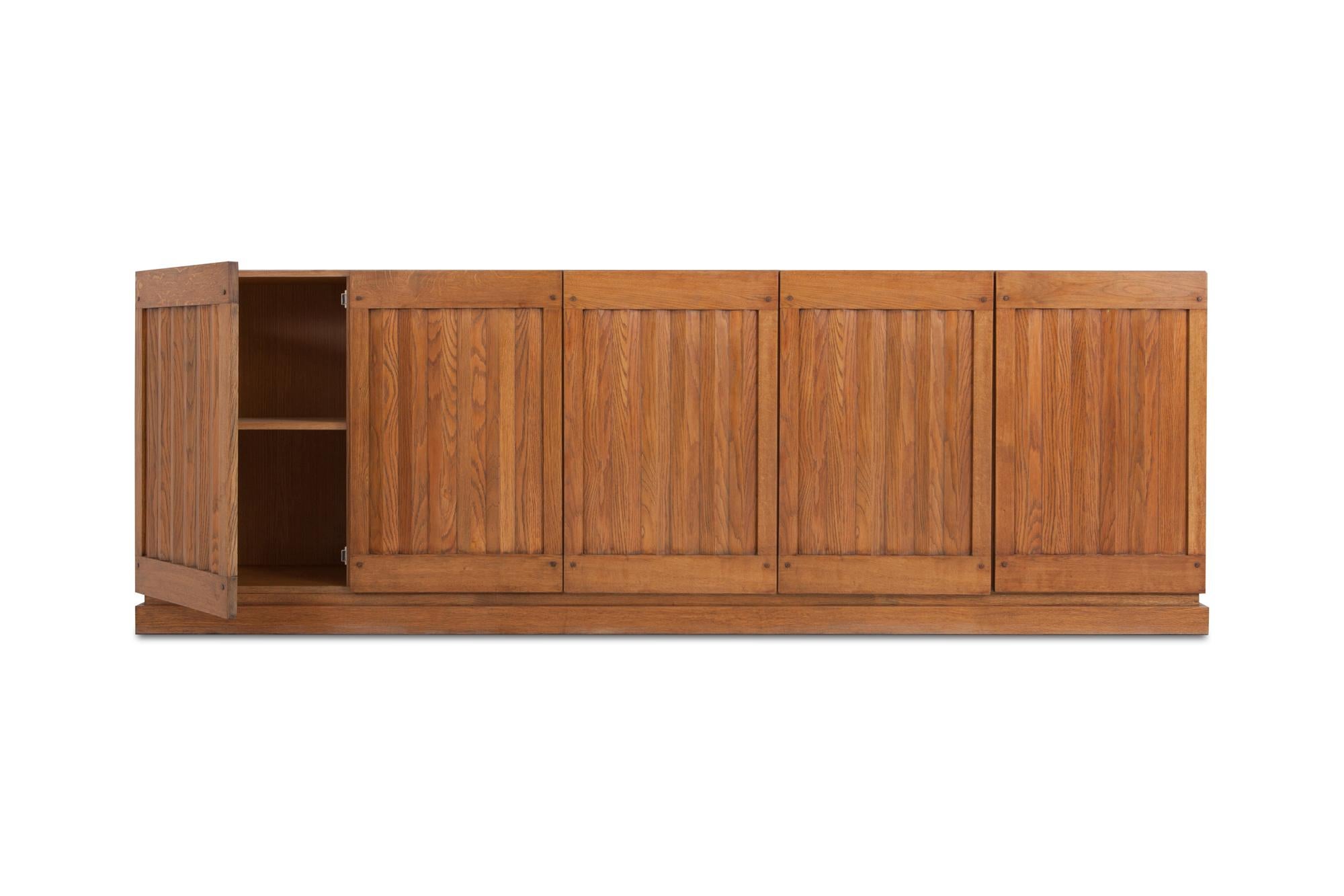Minimalist oak sideboard with geometrical door panelling.
Would fit well in a Brutalist, Minimalist interior as in a more Hollywood Regency Kelly Wearstler inspired interior.
Belgium, 1970s.


 