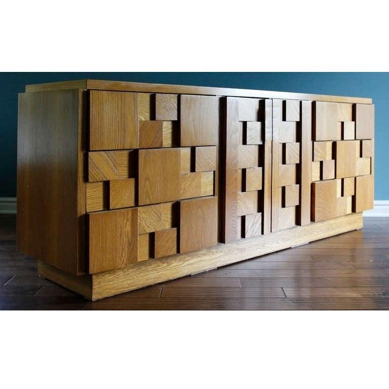 This strikingly handsome cubist fronted six-drawer credenza in natural wood finish made by The Lane Furniture Company in the 1960's, reference to the Paul Evans Cityscape line. This chest of drawers has two doors in the center section that open to