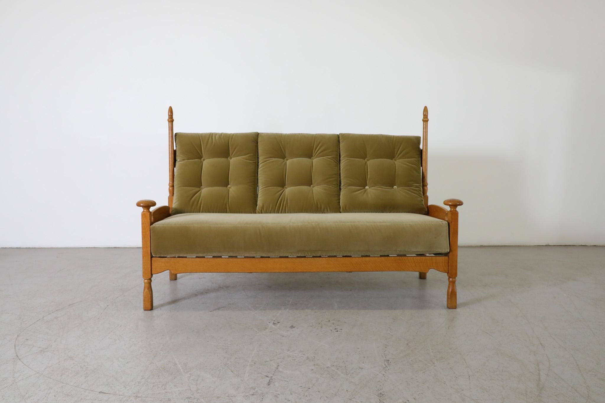 Rare and distinctively shaped oak sofa with large rounded finials at the front and high horn-shaped rods at the back. Very little information is available about this sofa but it is both visually appealing and extremely comfortable. The piece is