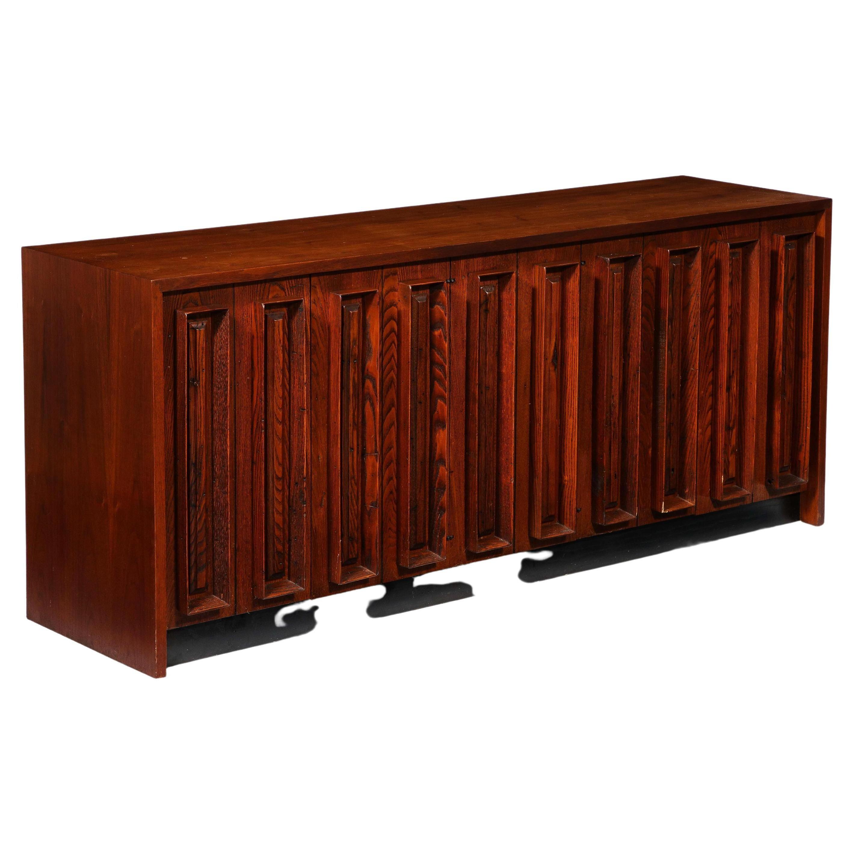 Stunning oak credenza on a black plinth with vertical slotted decor, it has five doors and multiple drawers and shelves. Very versatile design that can be used as storage or a multimedia unit.