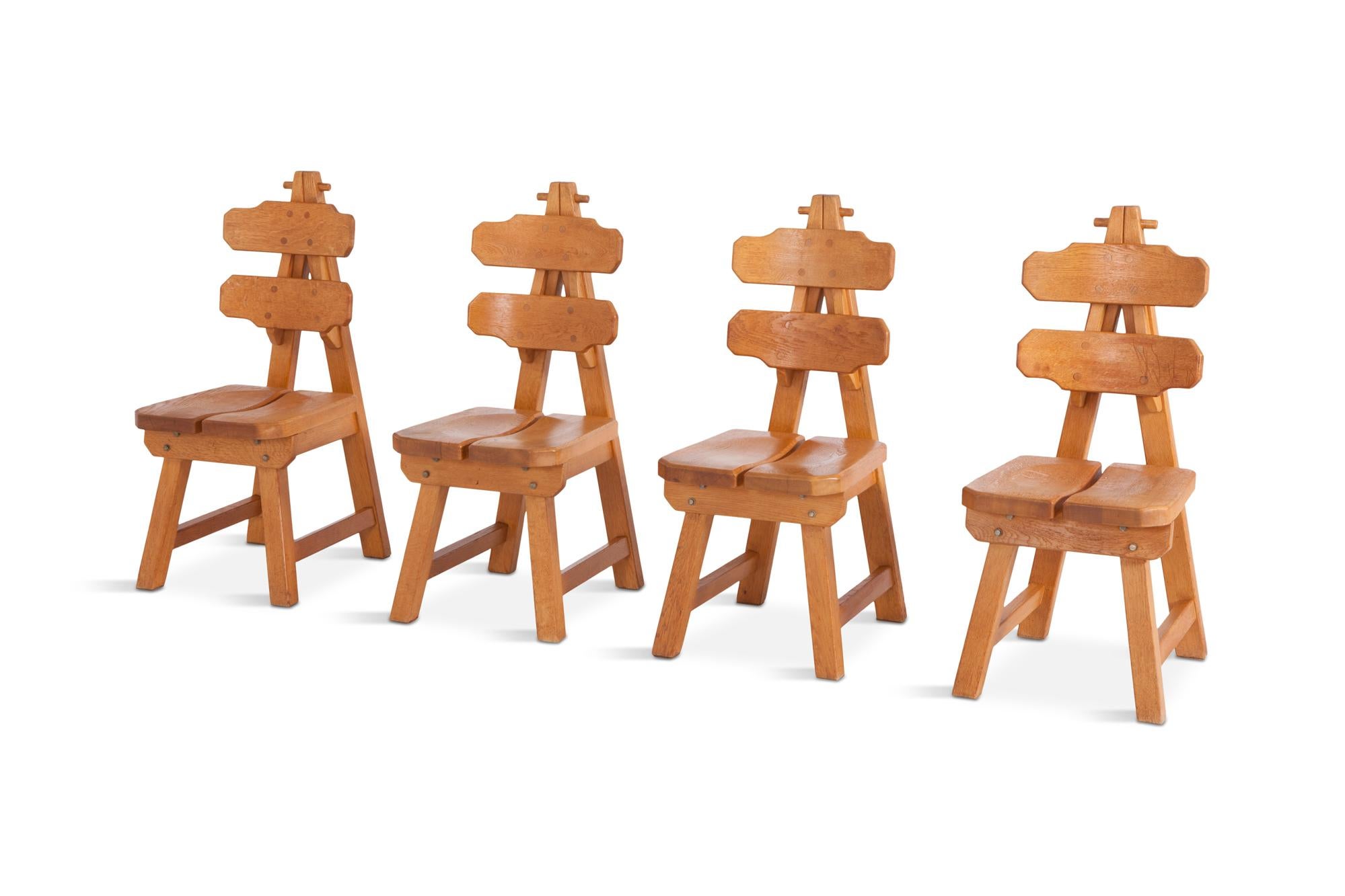 Mid-century modern Impressive set of four oak chairs.
A very sculptural and geometrical set.

We have an identical set of four in a darker stained oak. 

Spain, circa 1960.

Measure: W 44, D 57, H 103, SH 47 cm.
 