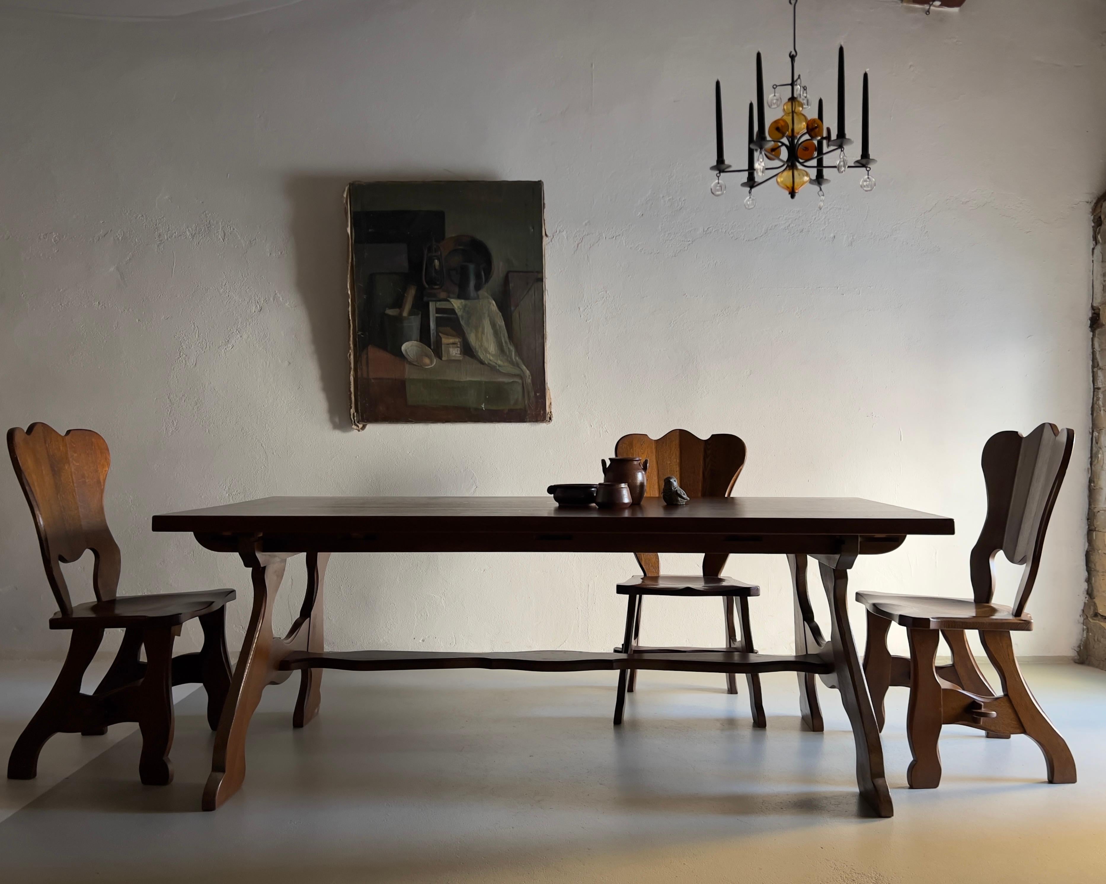 Dark solid oak dining table with a set of six matching chairs.

Dimensions:
Table (may be fully disassembled): H(table/tabletop) 74/4 cm, W 200 cm, D 84 cm
Chairs: H 98 cm, H(seat) 45 cm, W 49 cm, D 49 cm