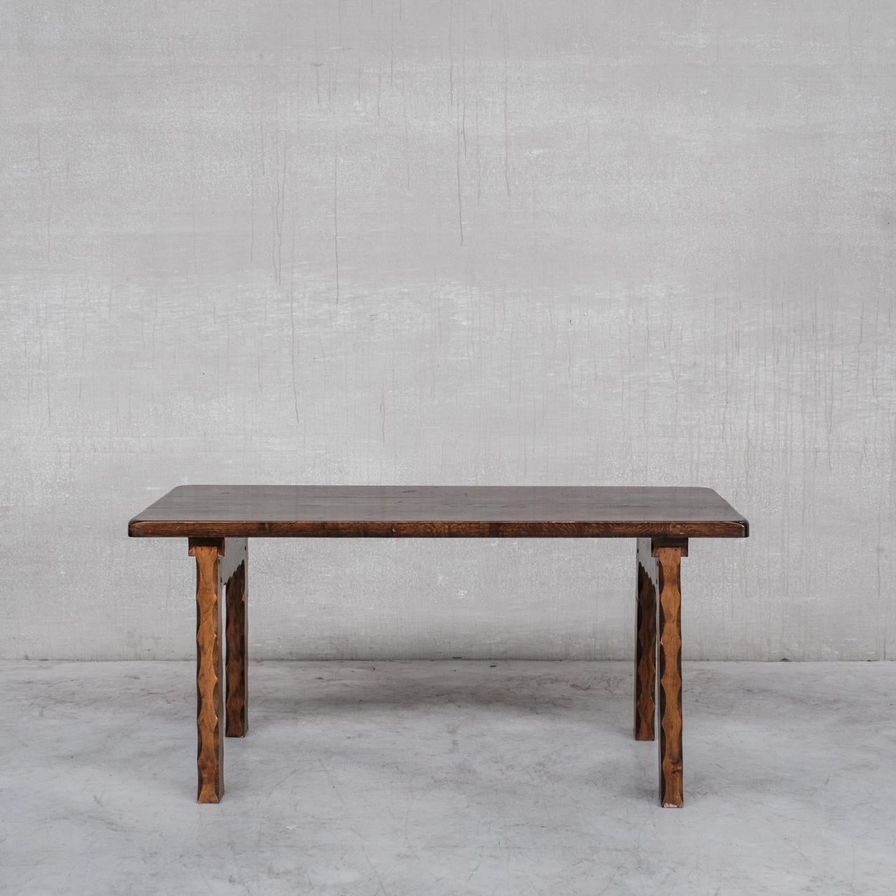An oak brutalist dining table. 

Holland, c1970s. 

Particuarly great carved curved legs to the piece. 

Remains in good condition, some scuffs and wear commensurate with age. 

Location: Belgium Gallery.

Dimensions: 165 W x 76 D x 77.5 H